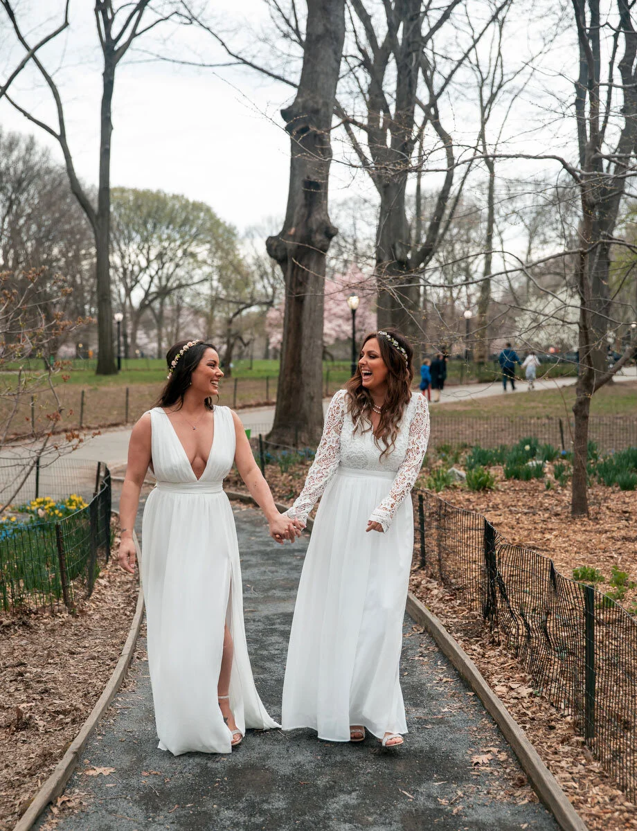 brides holding hands on path after elopement ceremony in NYC Central Park DAG Images