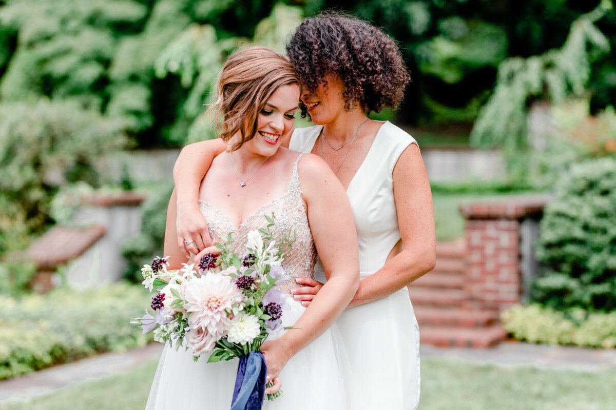 Celestial and Geode wedding inspiration in Winston Salem NC showing two brides in wedding dress and jumpsuit with bouquets Ariel Kaitlin Photography