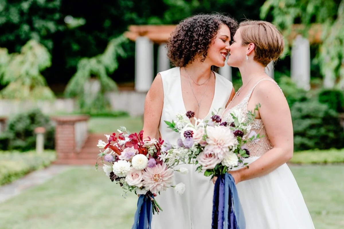 Celestial and Geode wedding inspiration in Winston Salem NC showing two brides in wedding dress and jumpsuit with bouquets Ariel Kaitlin Photography