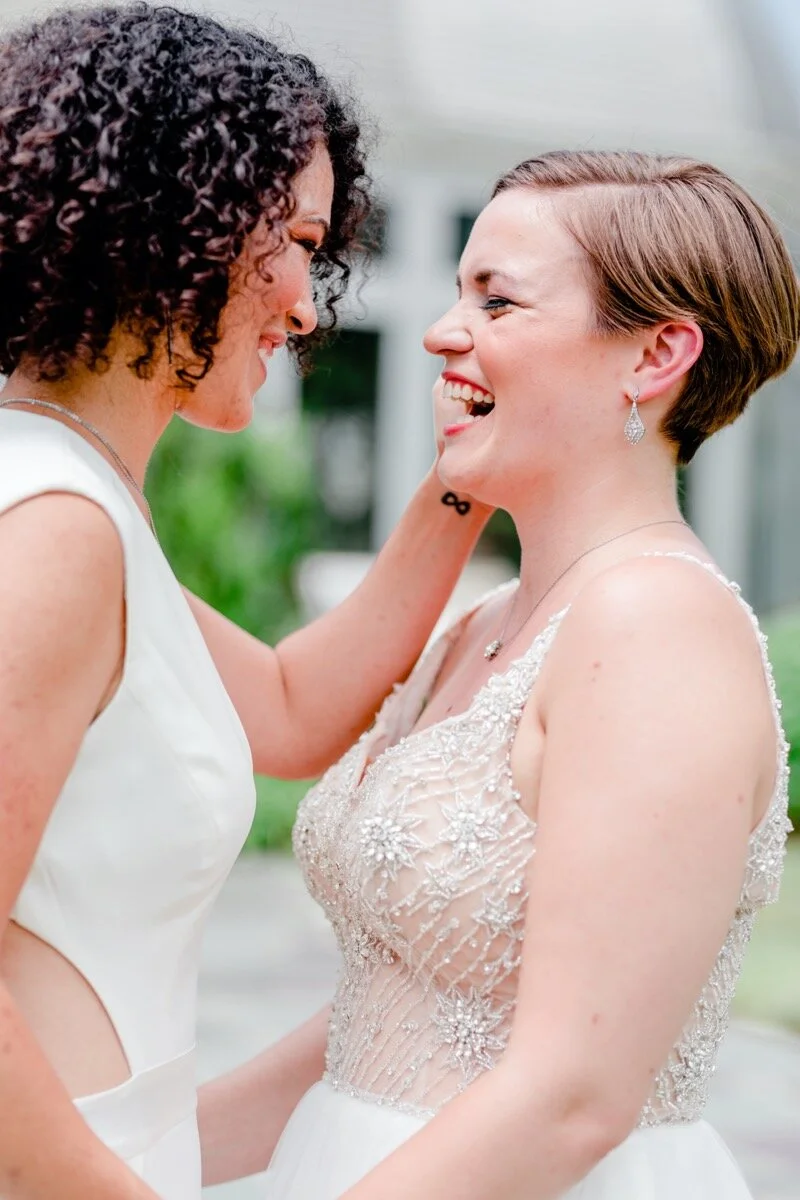Celestial and Geode wedding inspiration in Winston Salem NC showing two brides in wedding dress and jumpsuit kissing in front of greenhouse Ariel Kaitlin Photography