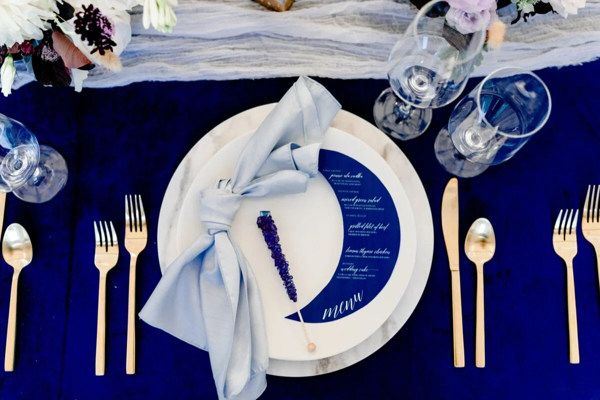 Celestial and Geode wedding inspiration in Winston Salem NC showing cobalt blue and gold moon menu and table setting Ariel Kaitlin Photography