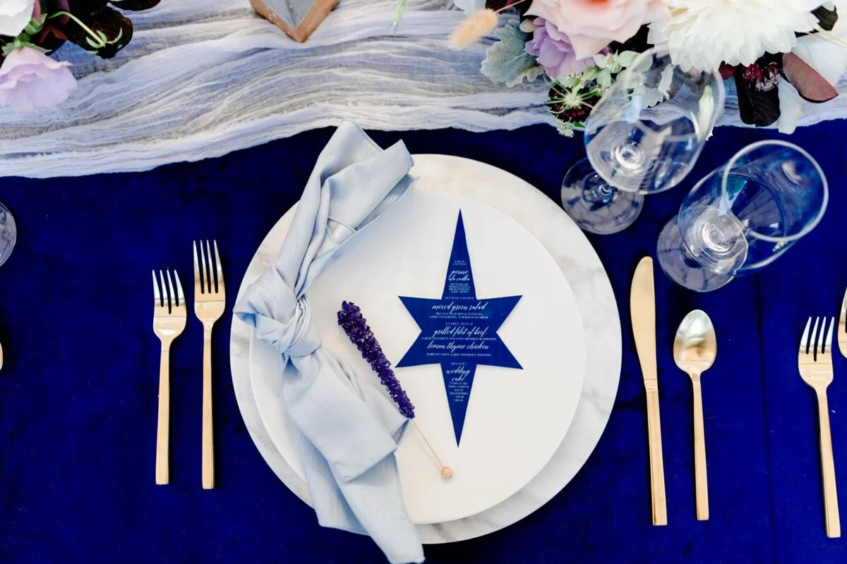 Celestial and Geode wedding inspiration in Winston Salem NC showing cobalt blue and gold star menu and table setting Ariel Kaitlin Photography
