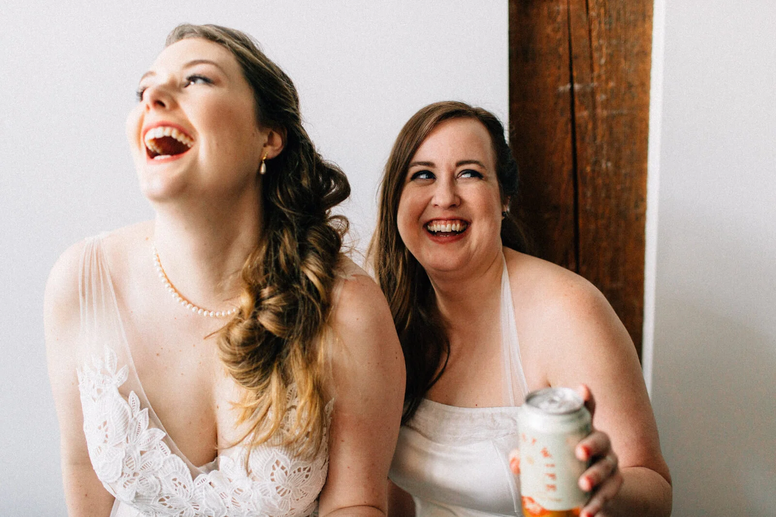 LGBTQ+ couple laugh together after wedding in Seattle Fuck Yeah Weddings