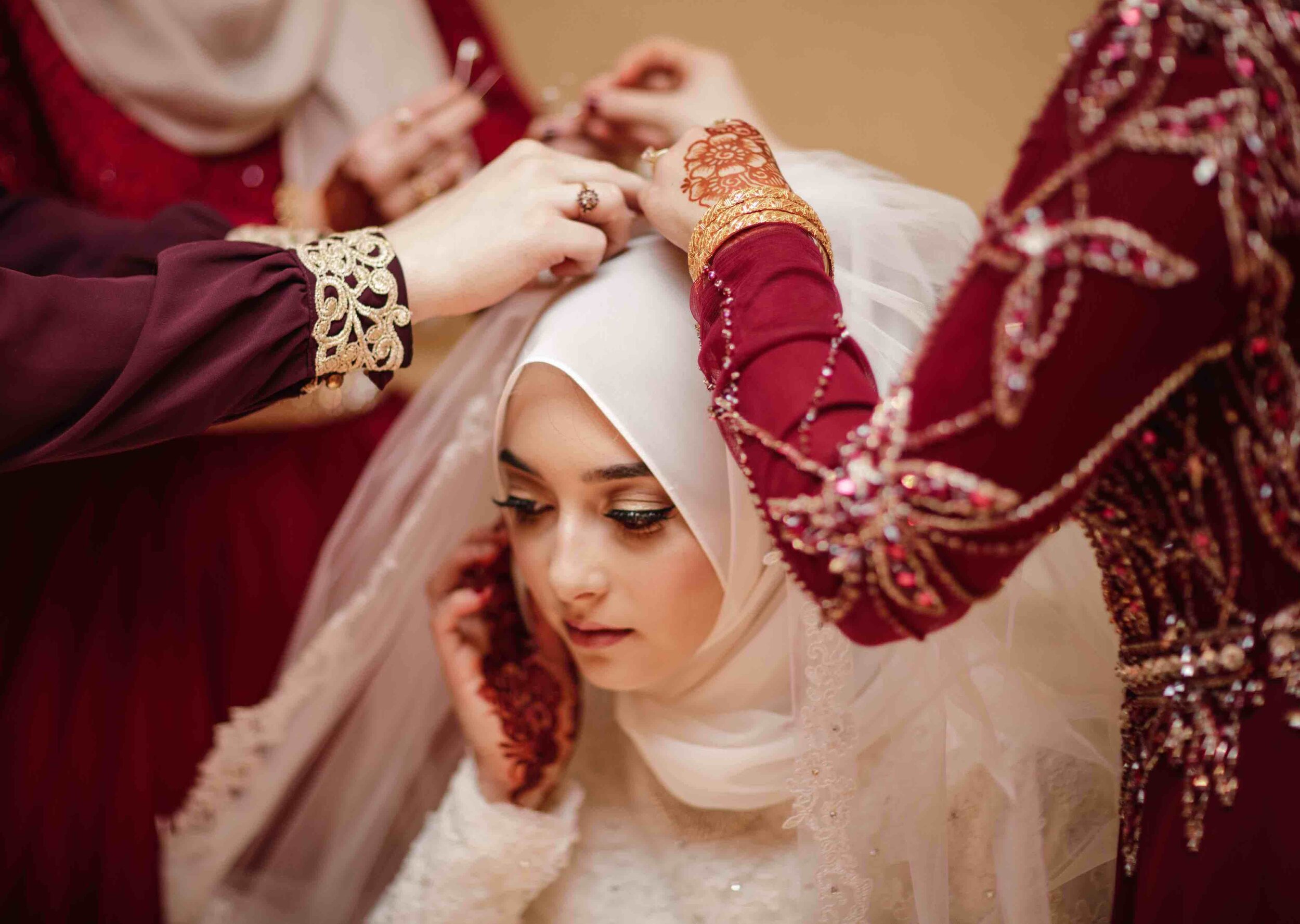 Bride gets ready before Arabic wedding ceremony with help of family by Teresa Johnson New England Wedding Photographer 