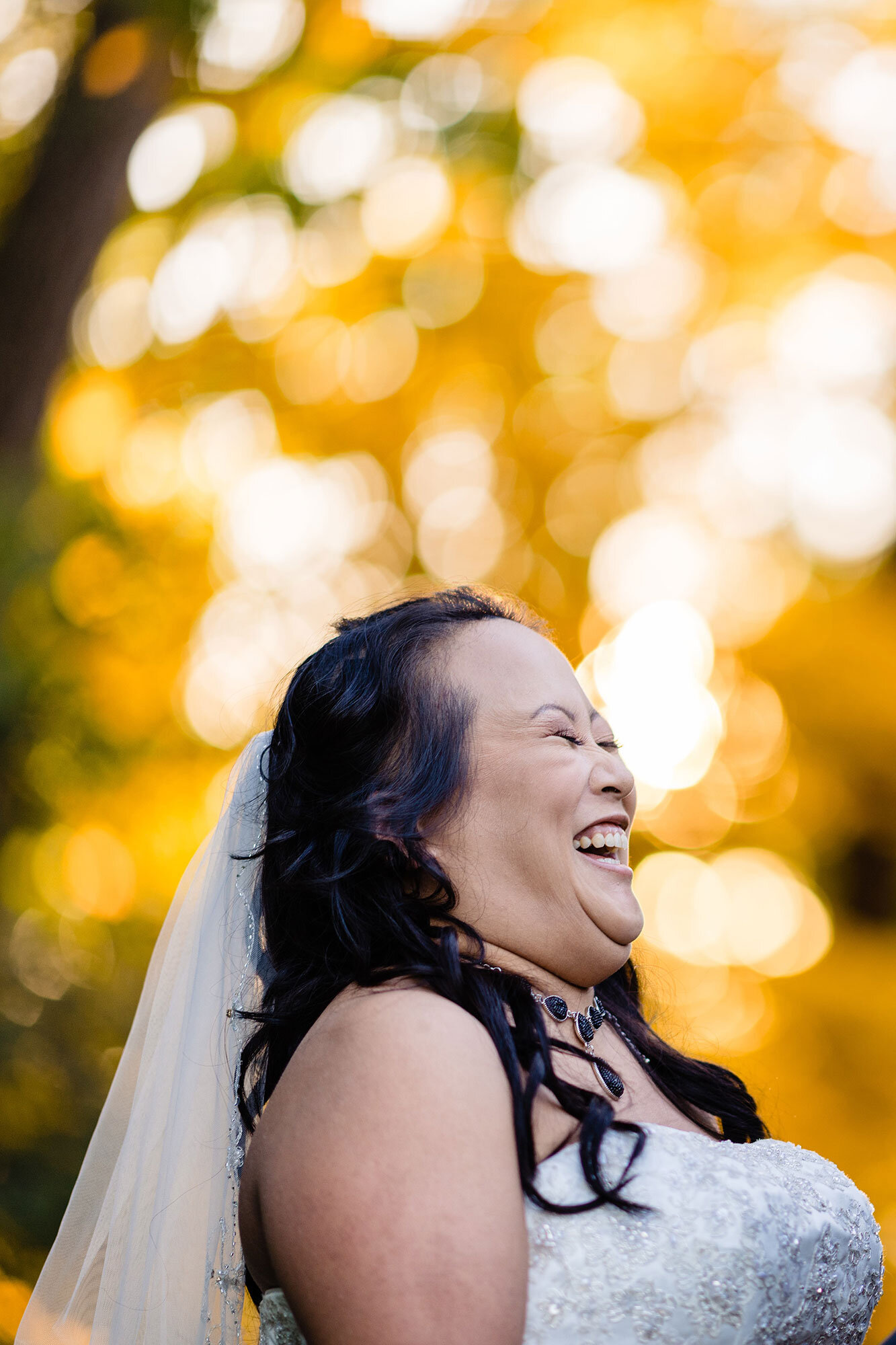 Bride laughs during fall wedding ceremony by Teresa Johnson New England Wedding Photographer