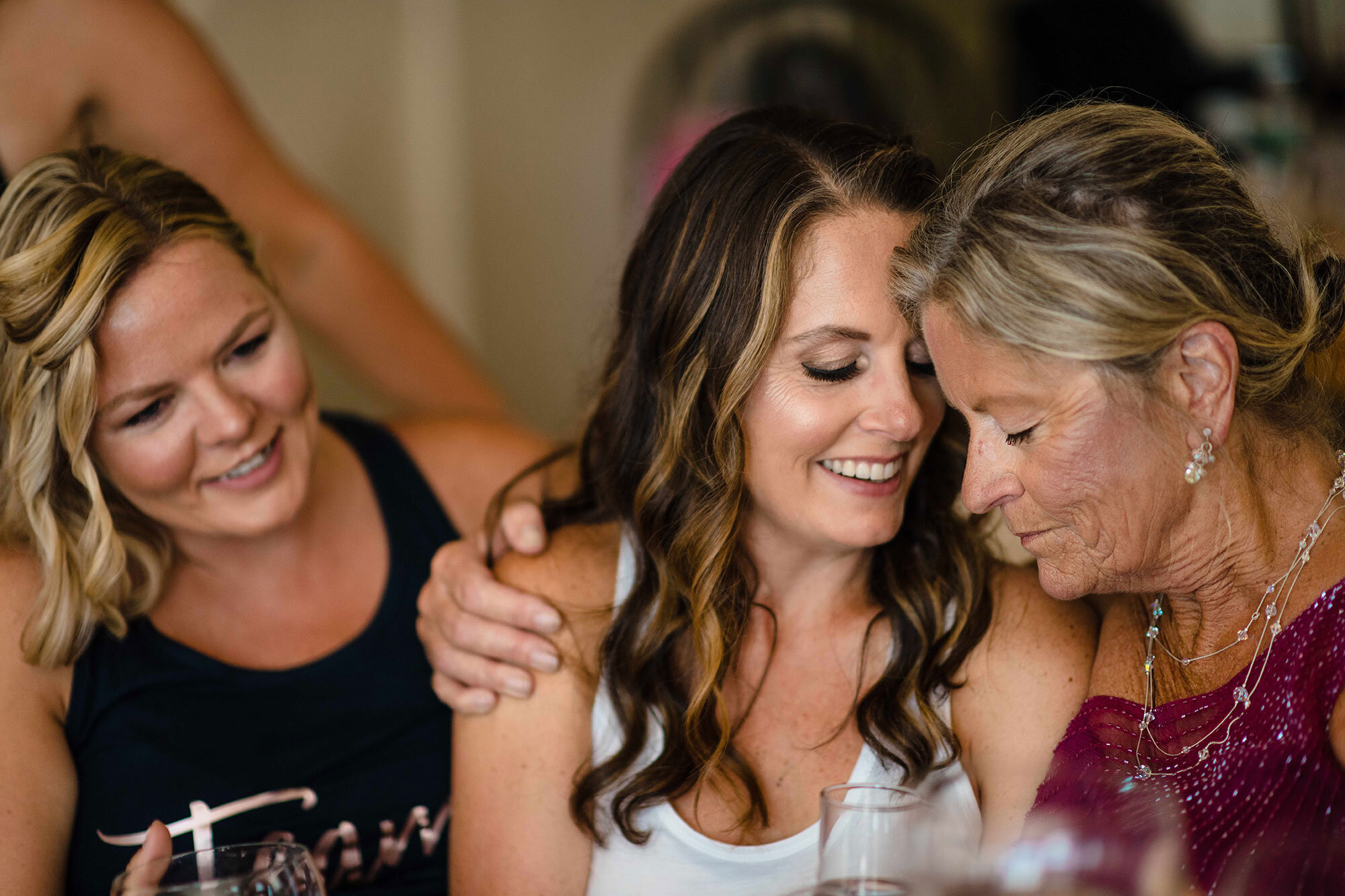 Bride hugs family and wedding party while getting ready before ceremony by Teresa Johnson Connecticut Wedding Photographer