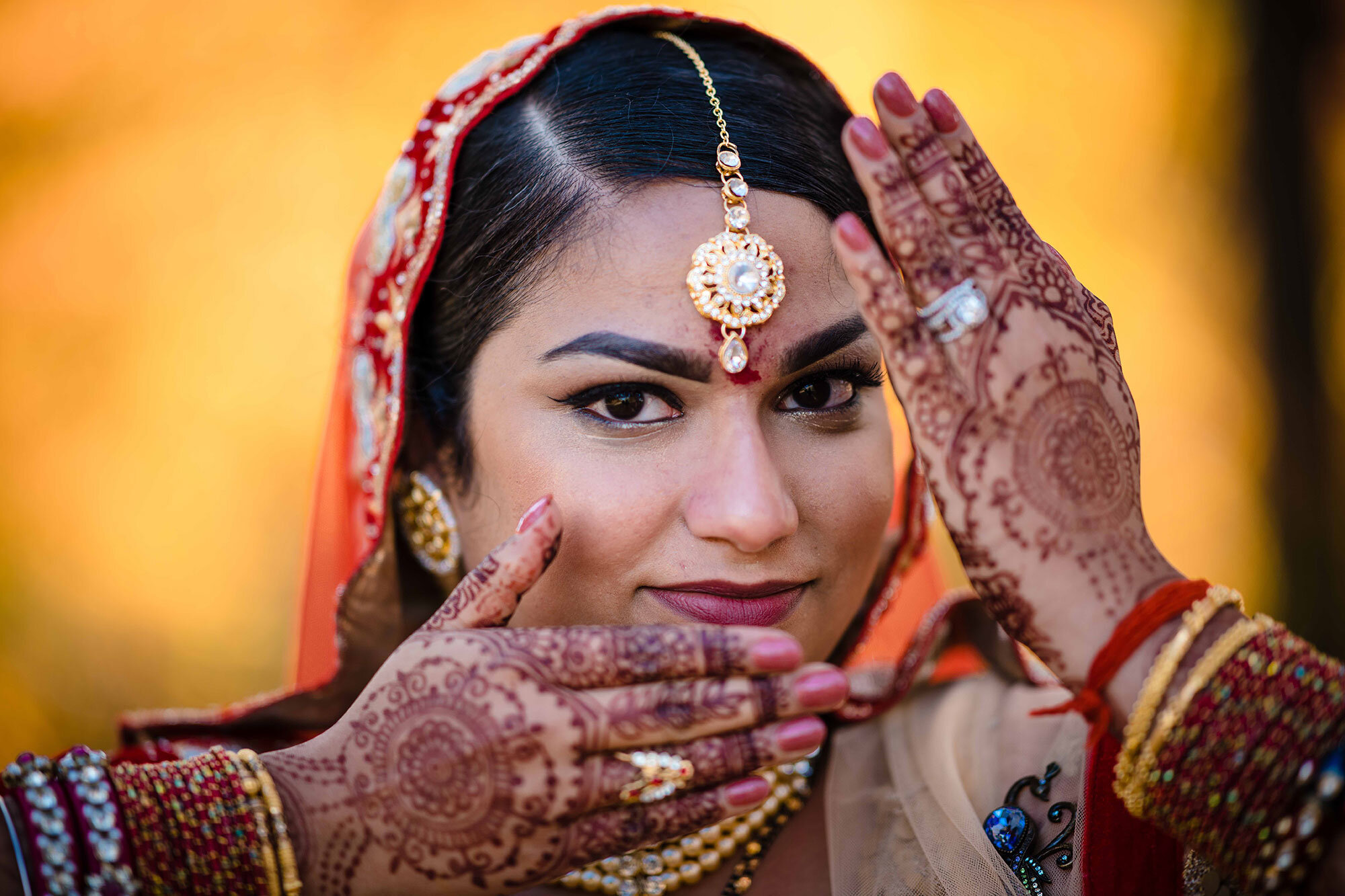 Bride smiles and shows off henna before Hindu wedding ceremony Teresa Johnson Connecticut Wedding Photographer