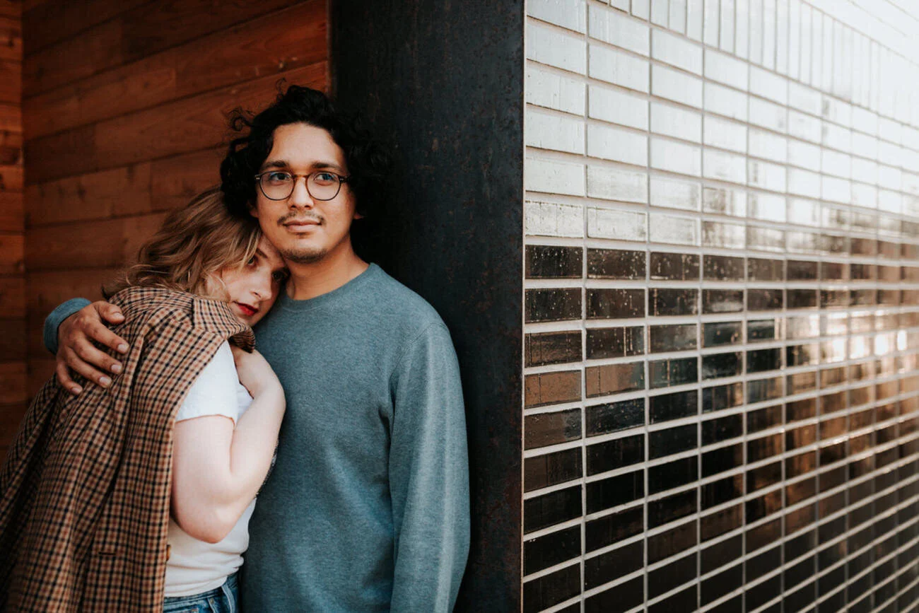 Engaged couple embrace in alcove next to tile wall Diana Ascarrunz Austin Texas Wedding Photographer