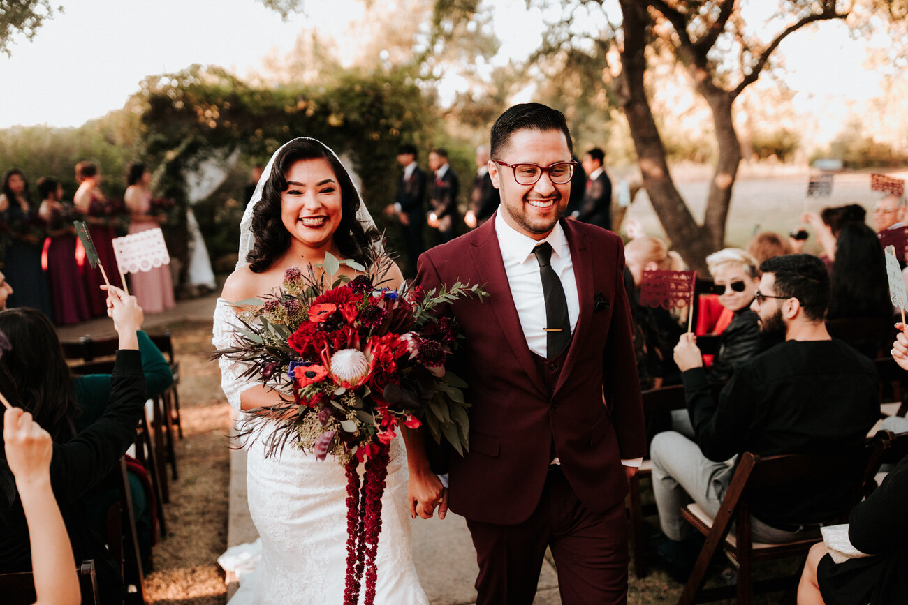 Newlywed couple walk down aisle after ceremony Diana Ascarrunz Austin Wedding Photographer