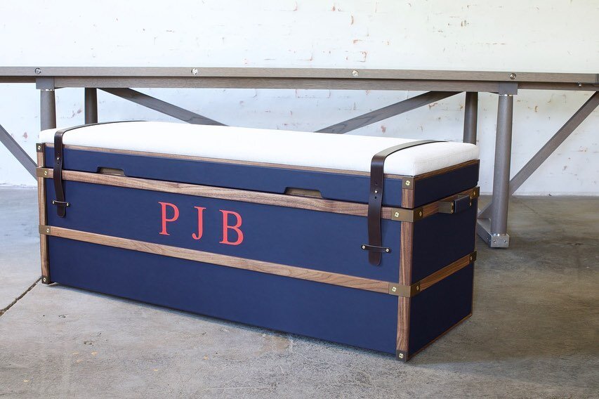 It always takes a team to produce a piece of furniture. Collin in New Hampshire built the case work and hand painted the monograms; Frumencio sewed the inside panels and cushion, Courtney the leather straps and logo and Yotam, the trim work and the f