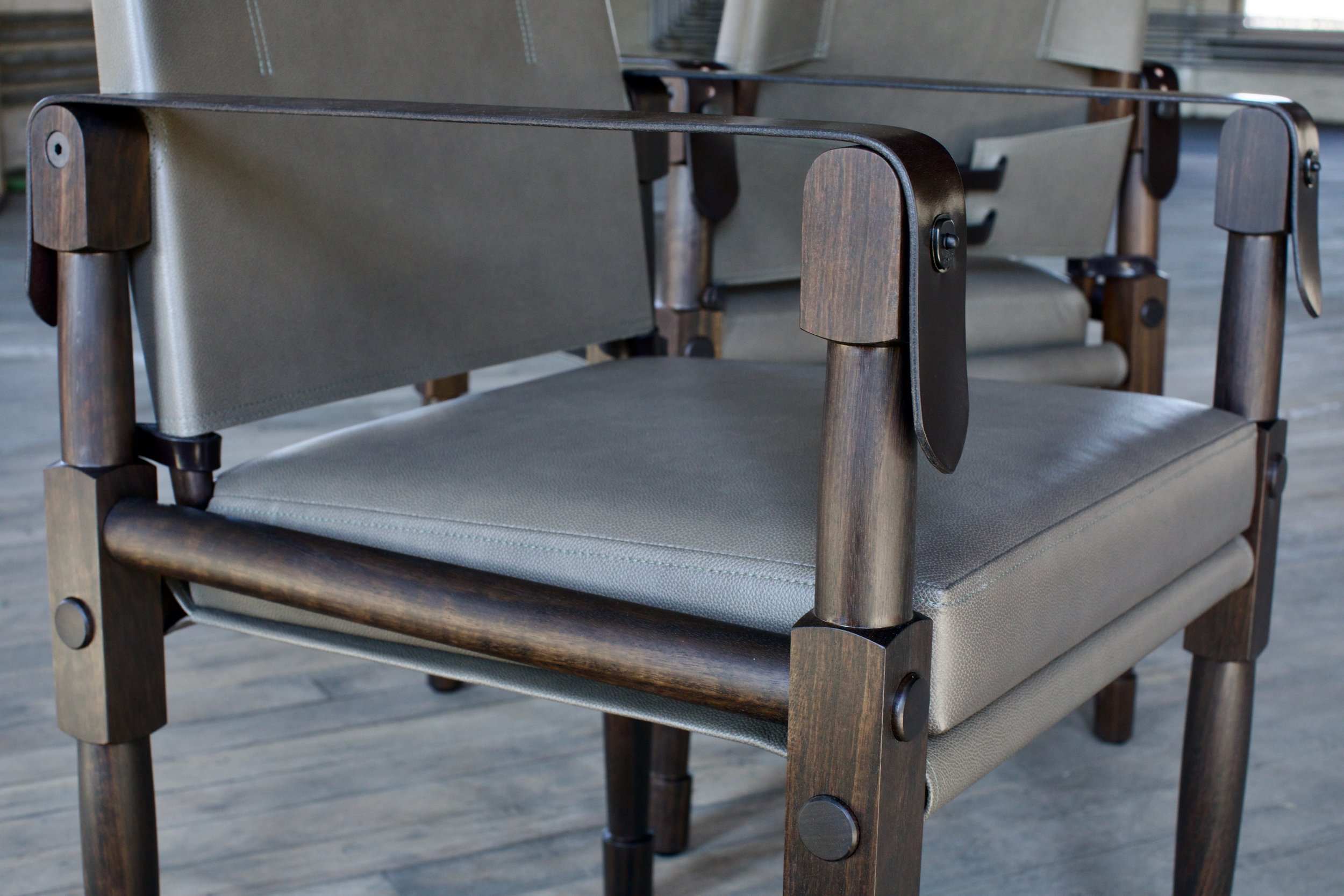  Wood and Finish: Fumed Eucalyptus - by special request  Upholstery: Cortina Leather - Vespa Tarragon  Leather Straps: Dark Chocolate English Bridle Leather  Blackened steel  05 