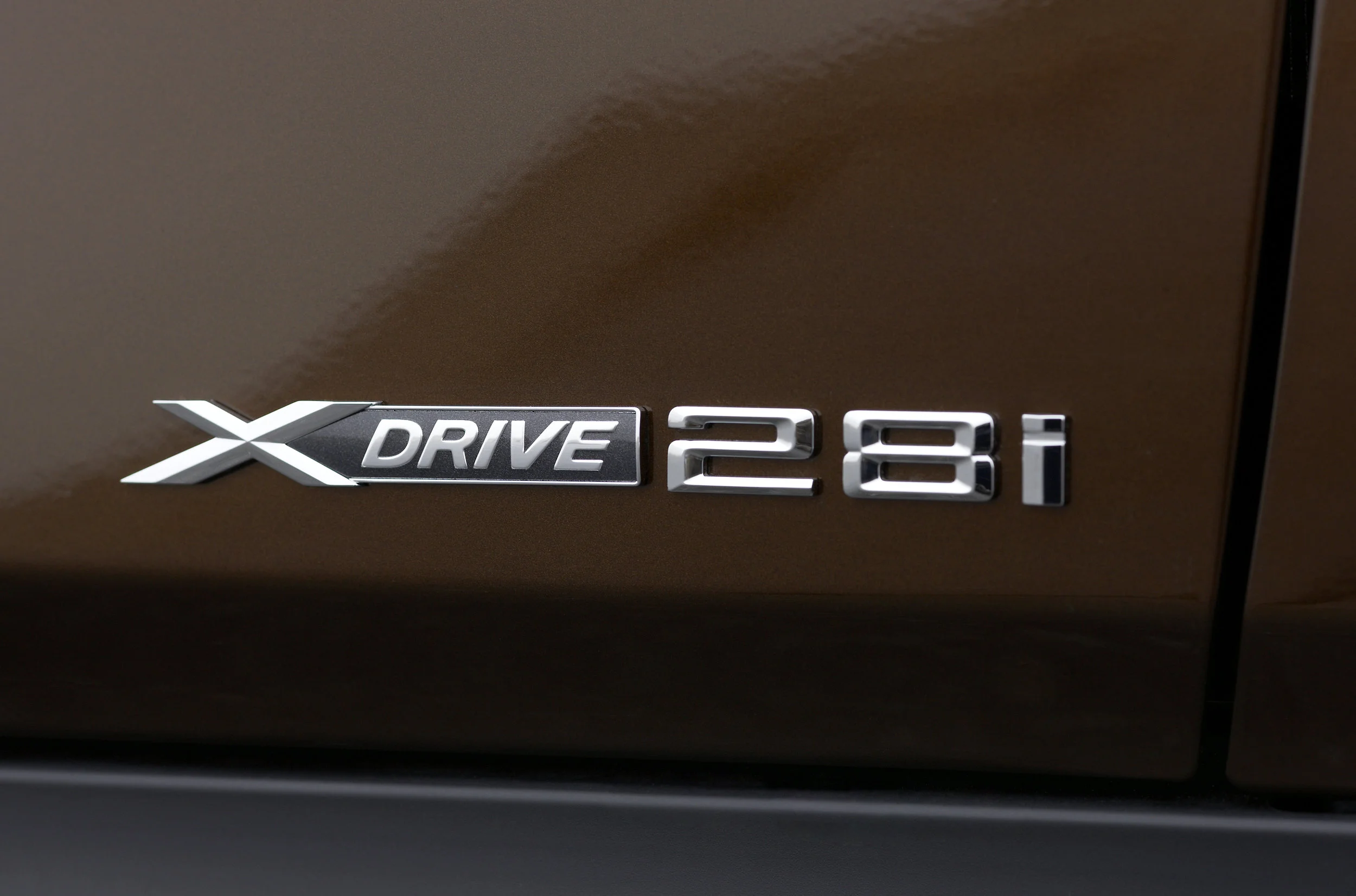 The badge above is from a BMW X1. Back in the 70s through the early 2000s, those two numbers would represent the engine displacement. However, the X1 does not have a 2.8-liter motor. It has a 2-liter motor. So what is this badge about? It's an homage to the days when base BMW motors were 2.8 liters . Somehow BMW thought that this number would matter to longtime brand loyalists. I don't think it does. 