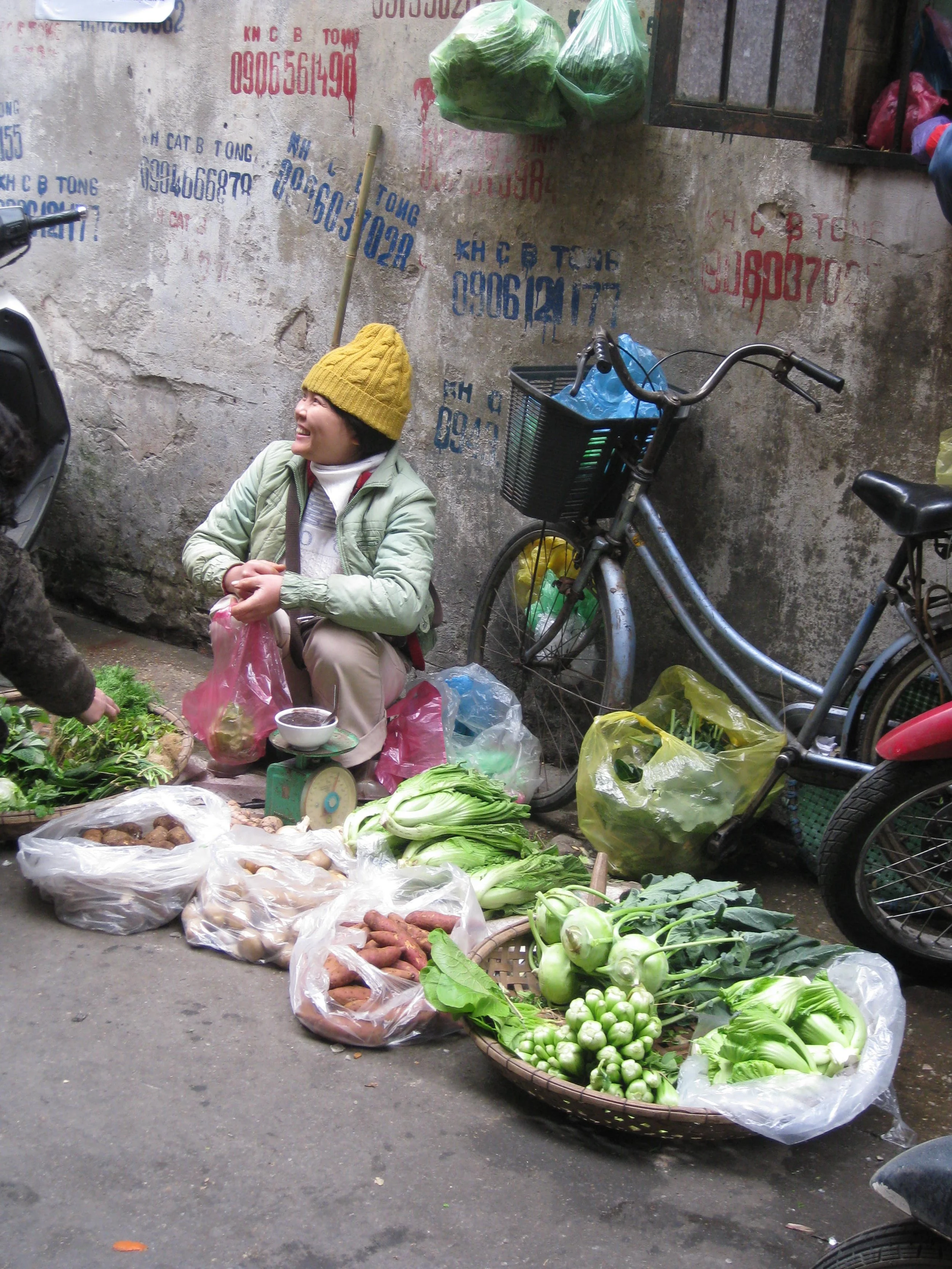 smiling lady and bike at market.JPG