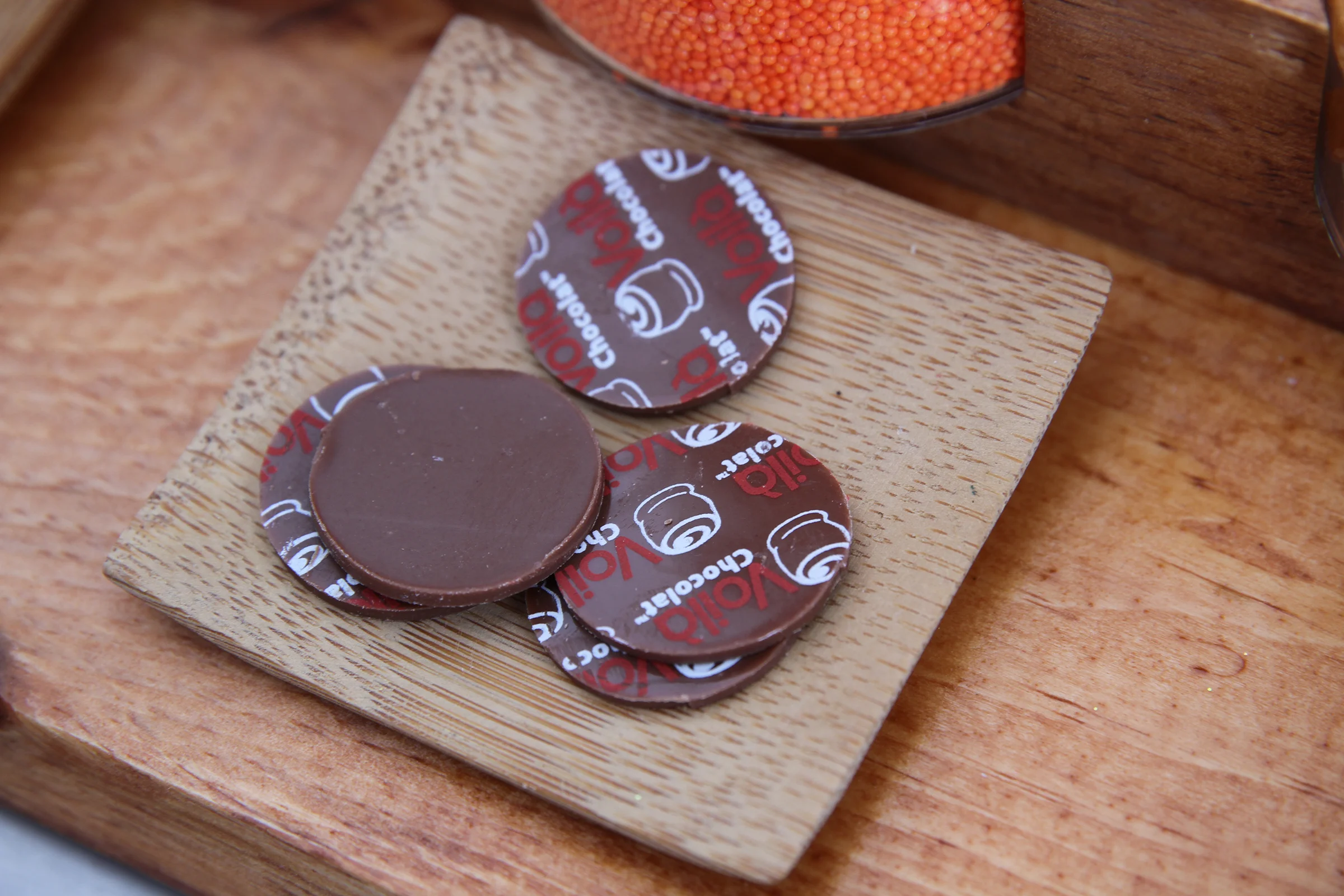 Plaquettes (literally, "small plaques" in French) are small circles of chocolate with your logo or design, which can be used to top round chocolates like truffles.