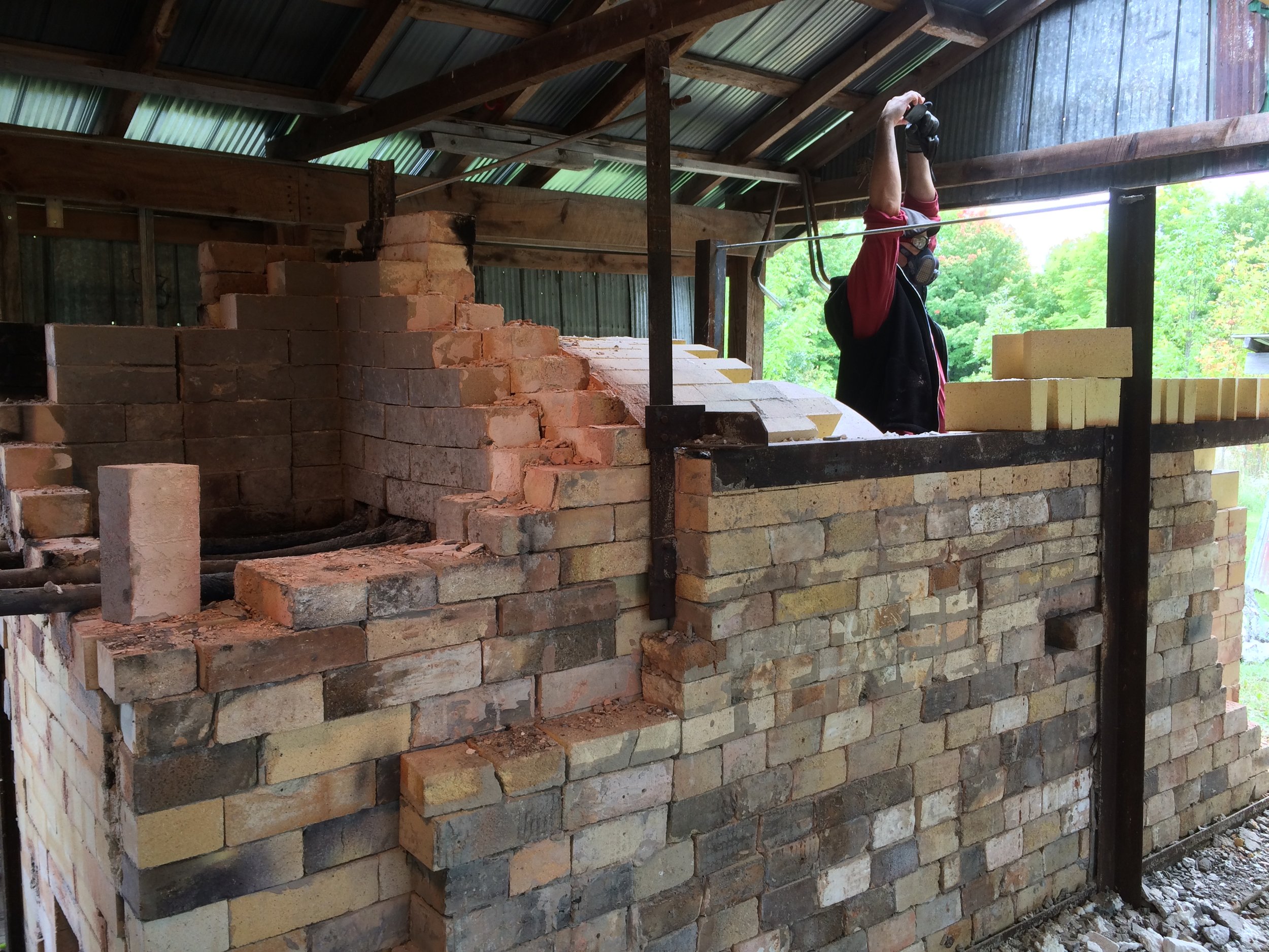 Step 4: Take down the firebox. This involved removing the steel for the door, taking off a top layer of shelves and fibre blanket, and slowly starting to hammer out the bricks one by one.