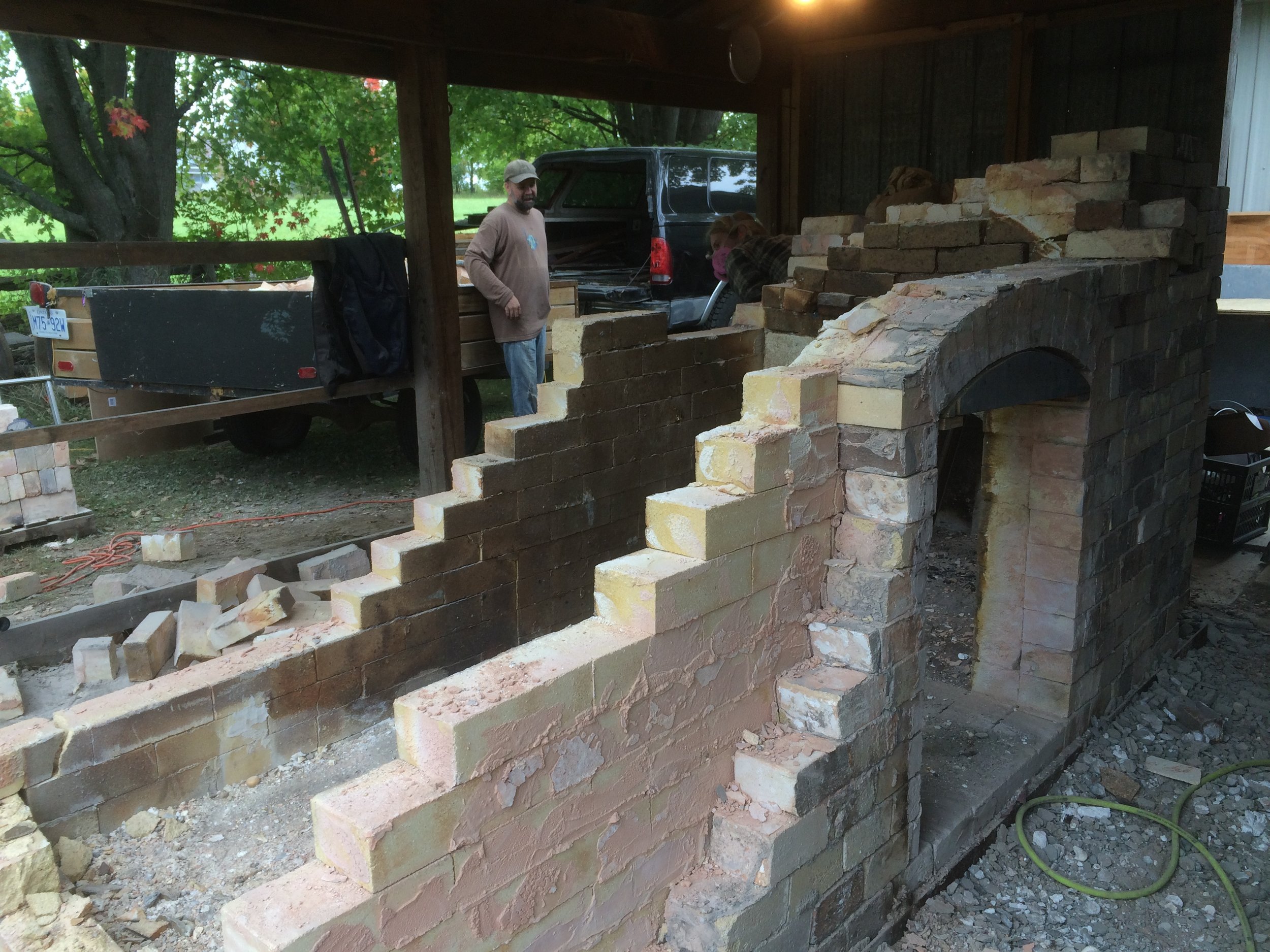 Step 5: Use any means possible to take the rest of the rear of the kiln down. For us this ranged from gentle tapping and chiselling, to me standing in the kiln whacking the back wall down with the sledgehammer. Some of the bricks were so stuck together that they were not salvageable.