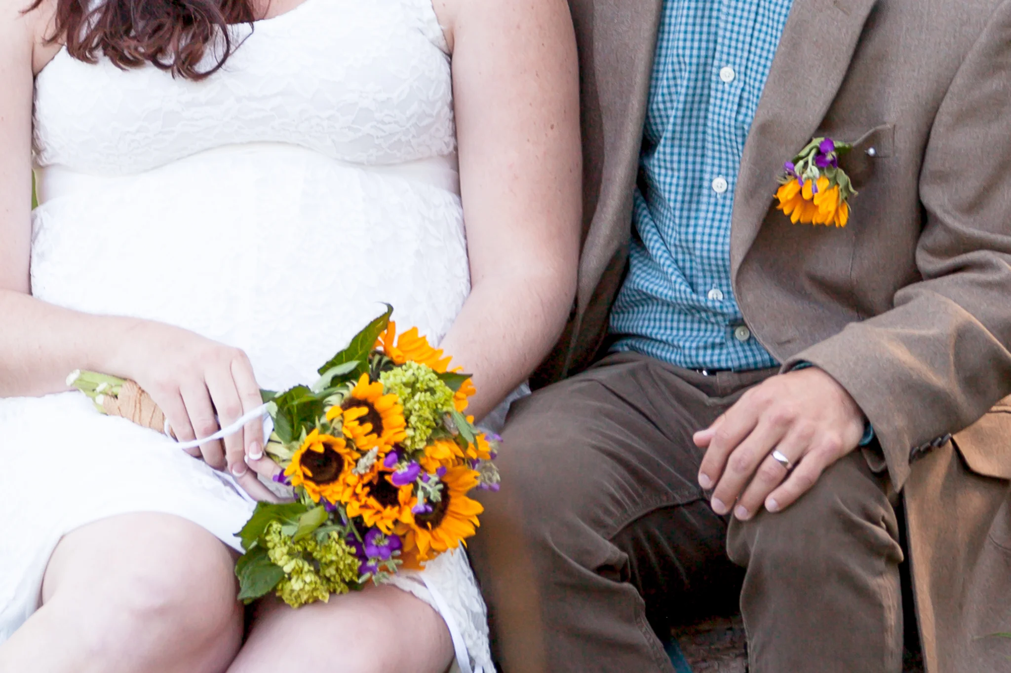colorado bride and groom hands resting with sunflowers in elopement at rocky mountain national park