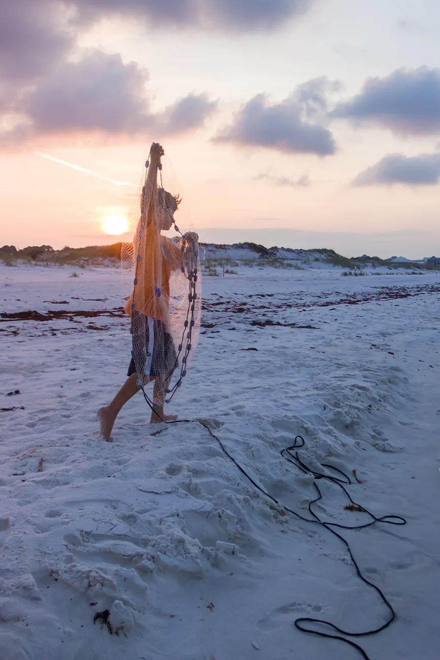 Hauling a casting net during sunrise.