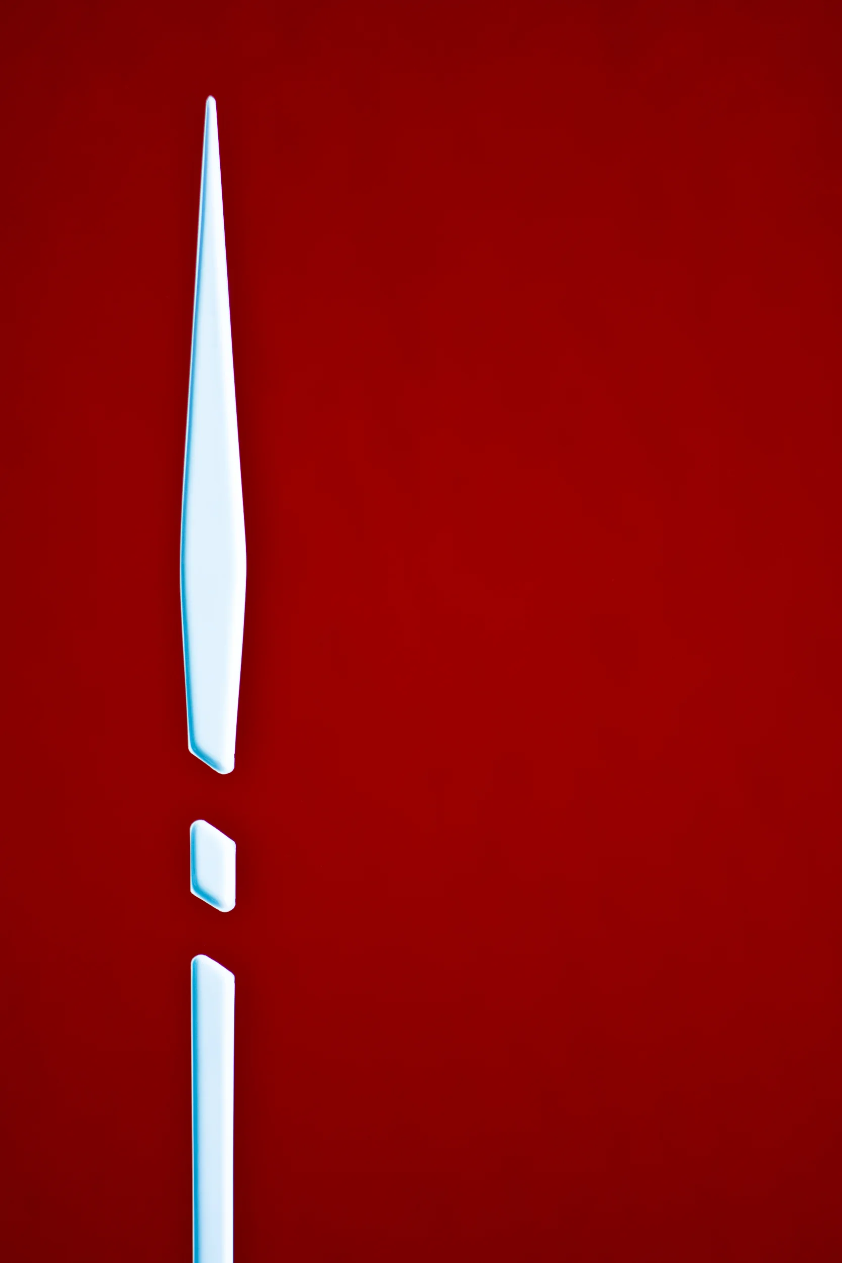 Sailboat detail of a white arrow on a red background.
