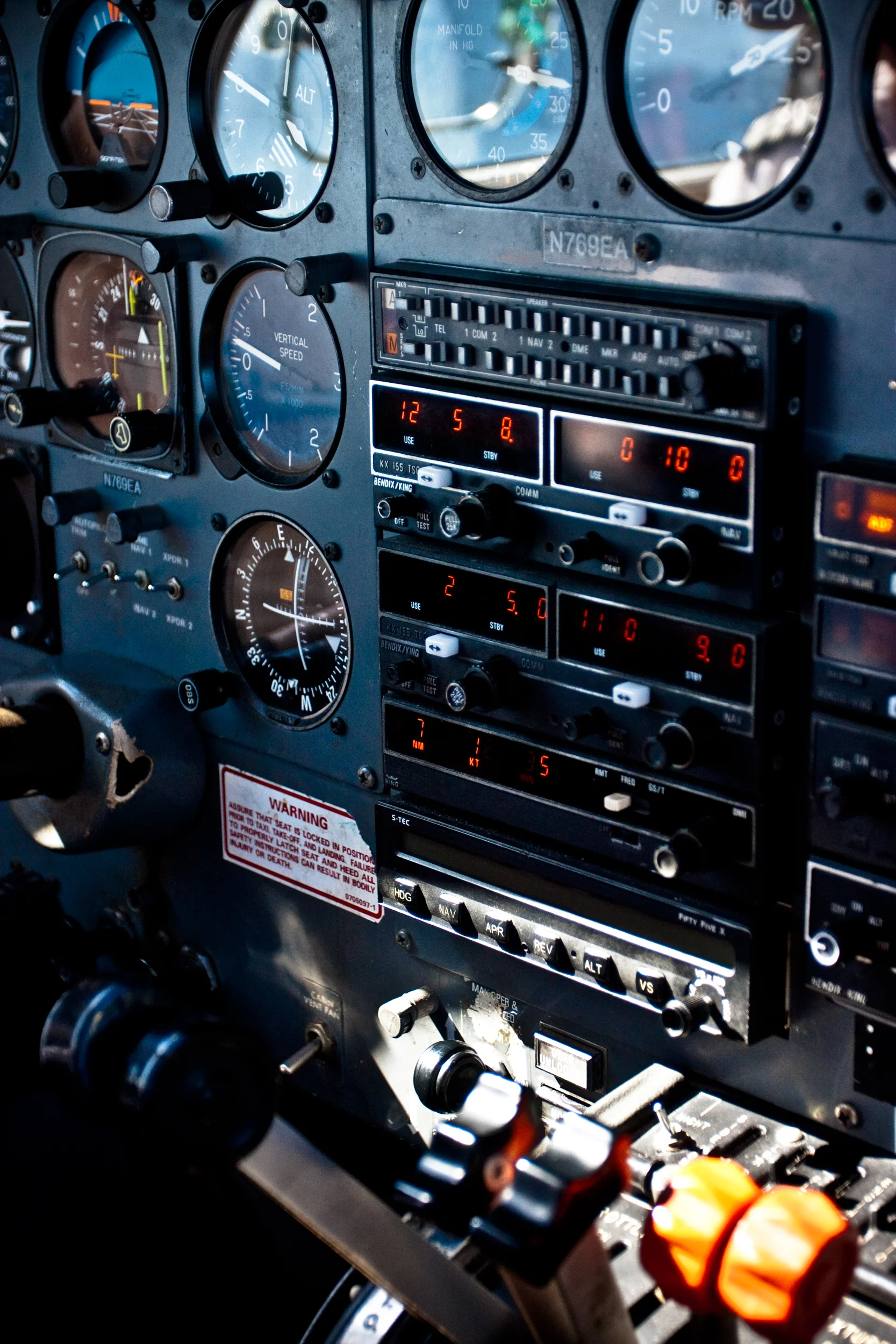 Detail shot of flight controls shot from the cockpit of a small plane.