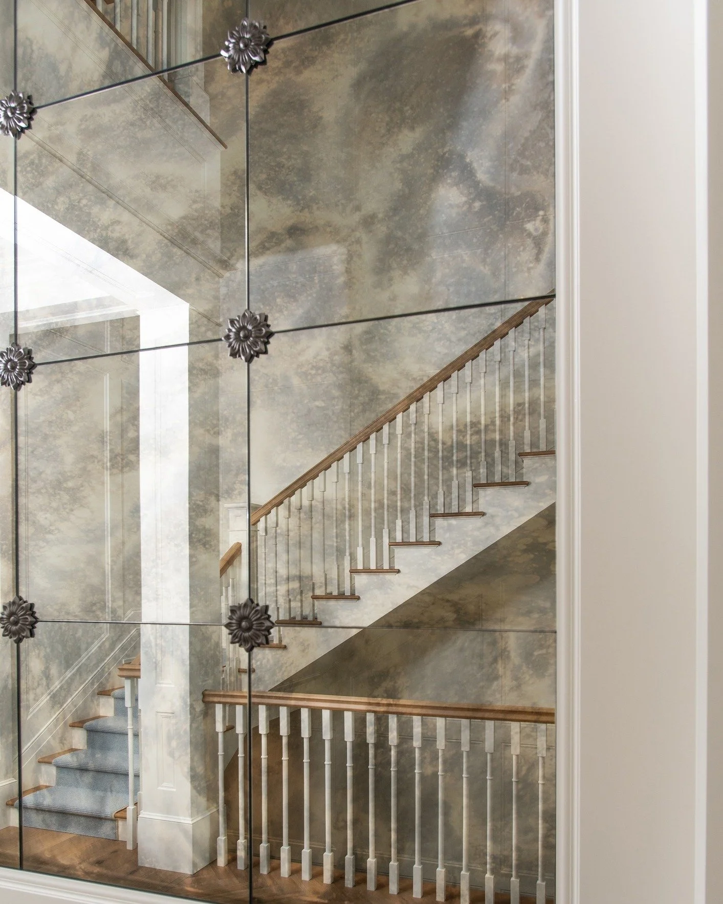 A moment of reflection, literally.

The staircase takes on a new dimension as it&rsquo;s mirrored through a smoky glass hallway display, creating depth, drama, and a sense of intrigue. Thoughtful details like this transform transitional spaces into i