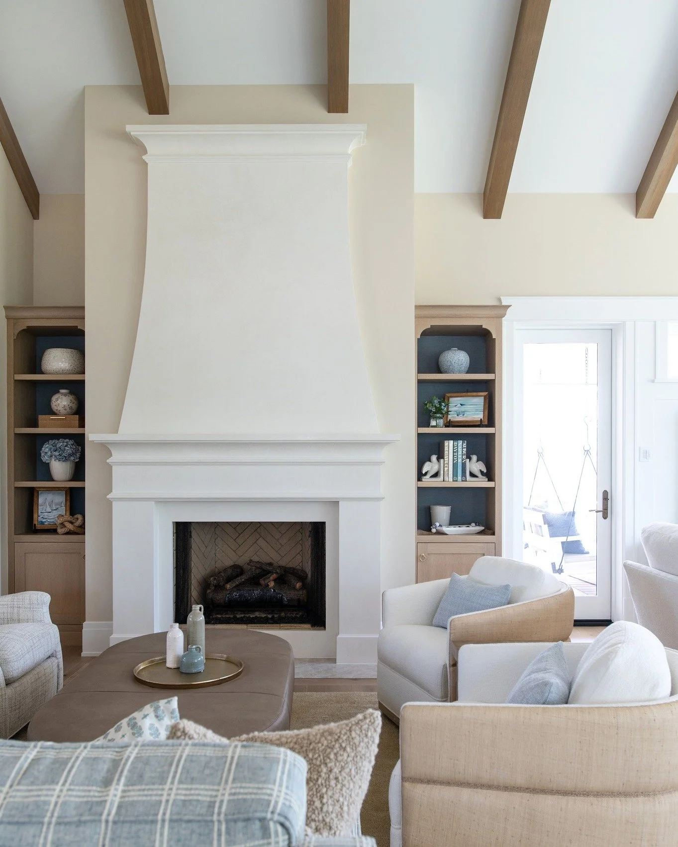 The warm wood tones of the built-ins, the soft contrast of the fireplace surround, and the natural texture overhead create a space that feels layered yet effortless. 

#benchmarkdesignstudio #mikeschaapbuilders #msbhuckleberryhill #livingroomdesign #