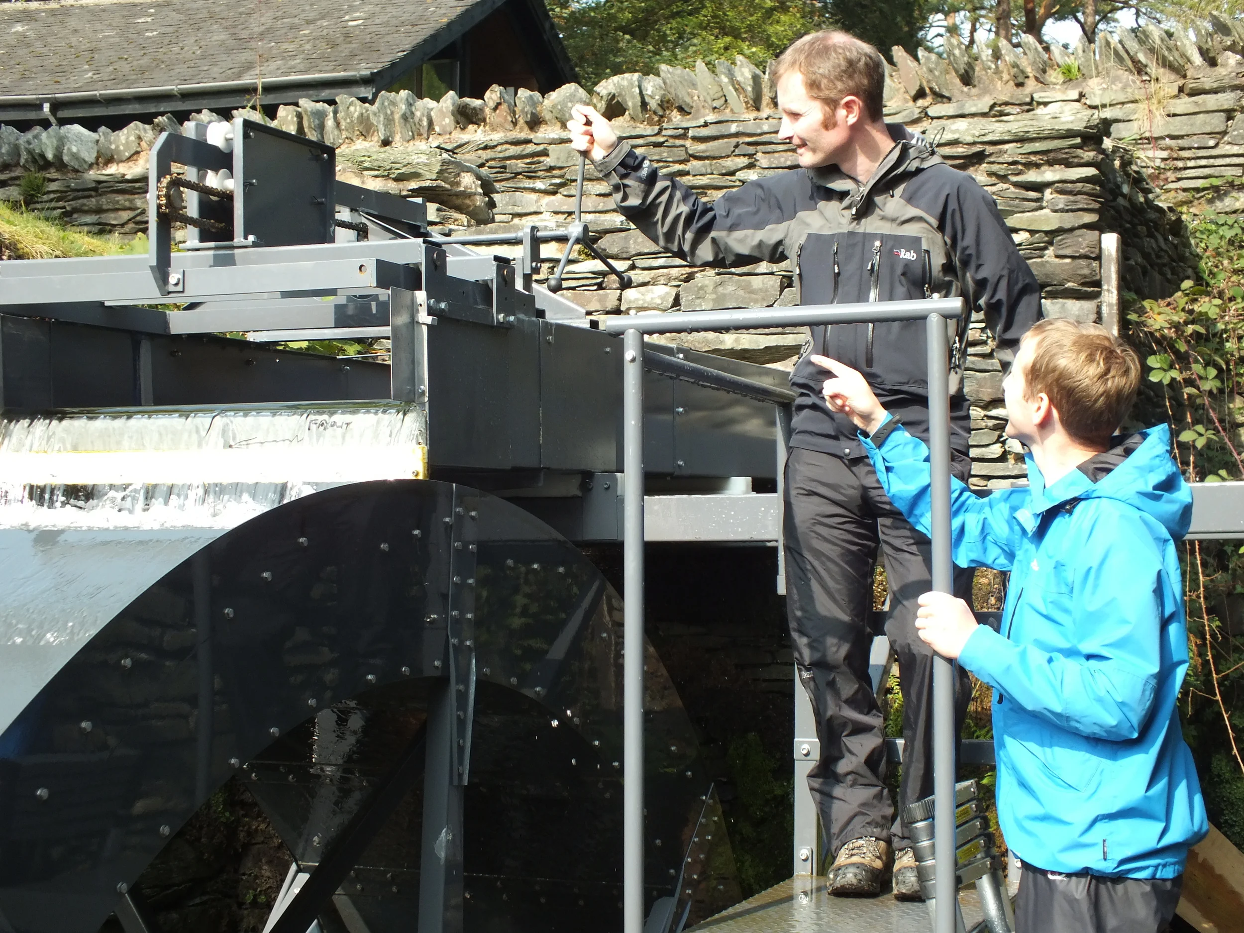 Dr Paddy Quinlan of the University of Cumbria using the adjustable launder as part of trials of the waterwheel with Jonathan Smith