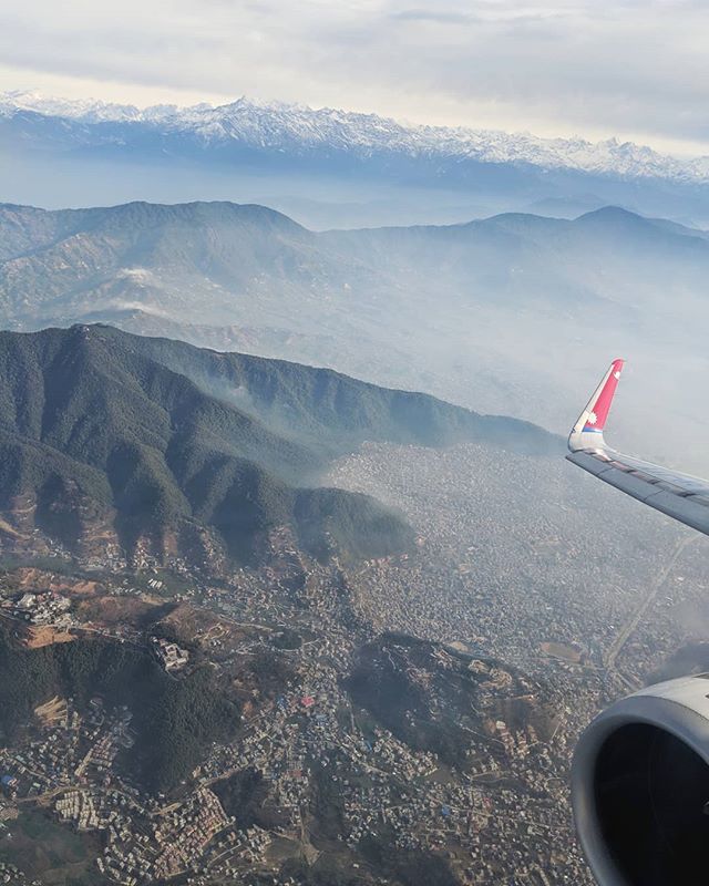 Kathmandu Valley from above: urban encroachment at the valley rim, the Nagarjun Forest Reserve, unseasonal early spring snows, smog. 🏗️🌳🏔️ #kathmandu #nepal #himalayas #urbanism