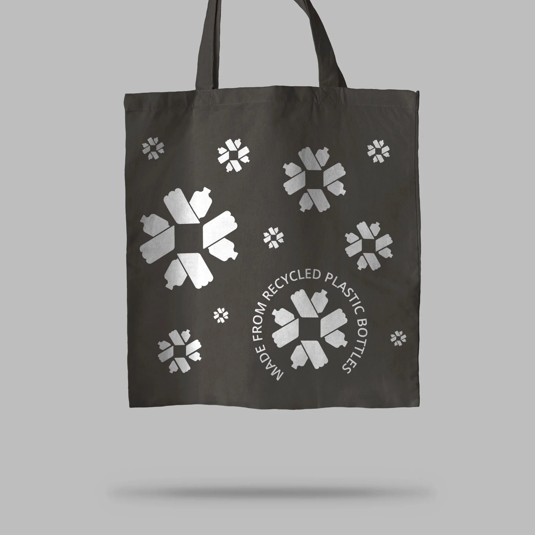 black_tote_bag_over_light_surface_mockup.jpg