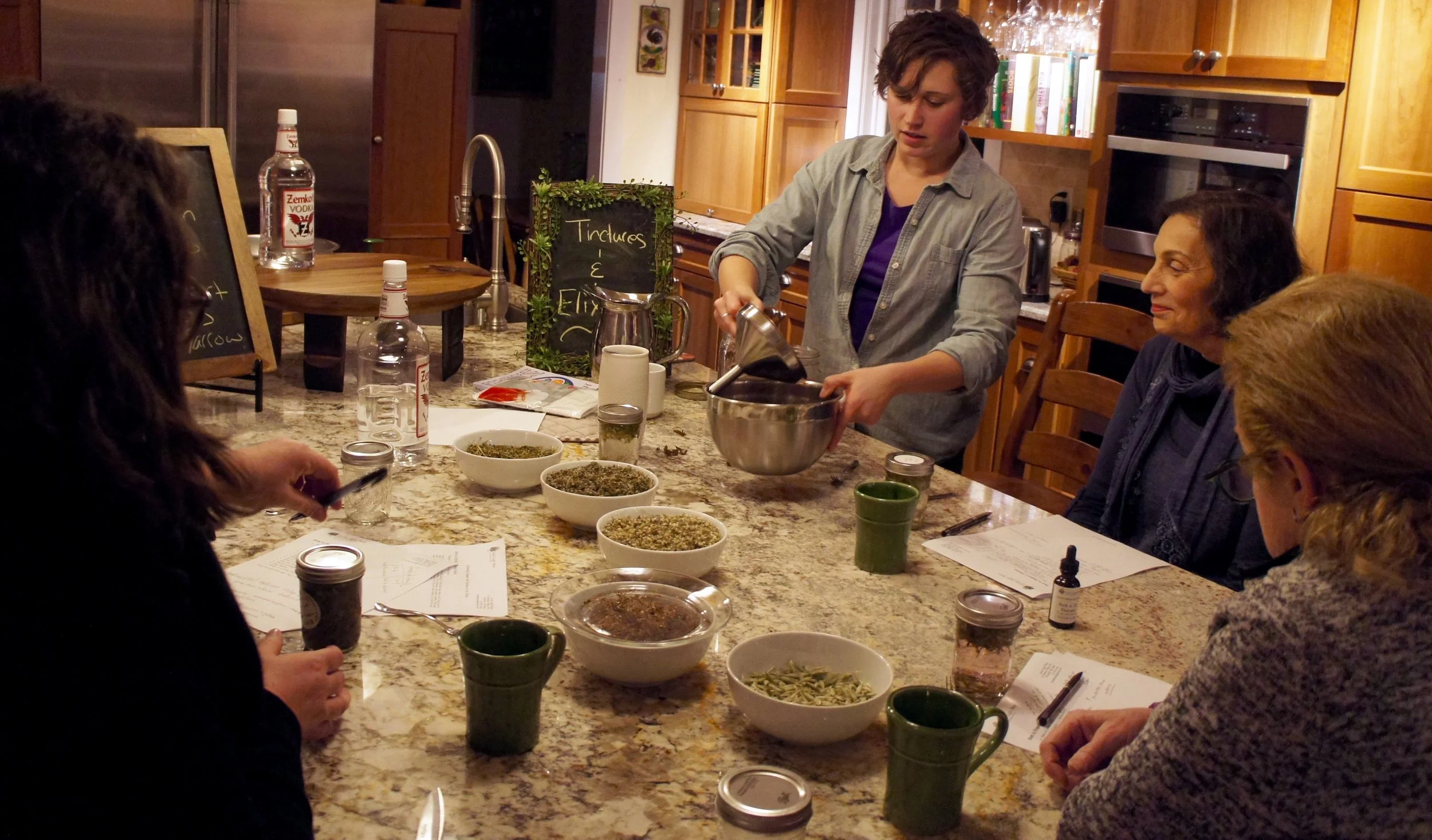 Straining a tincture in tincture-making class