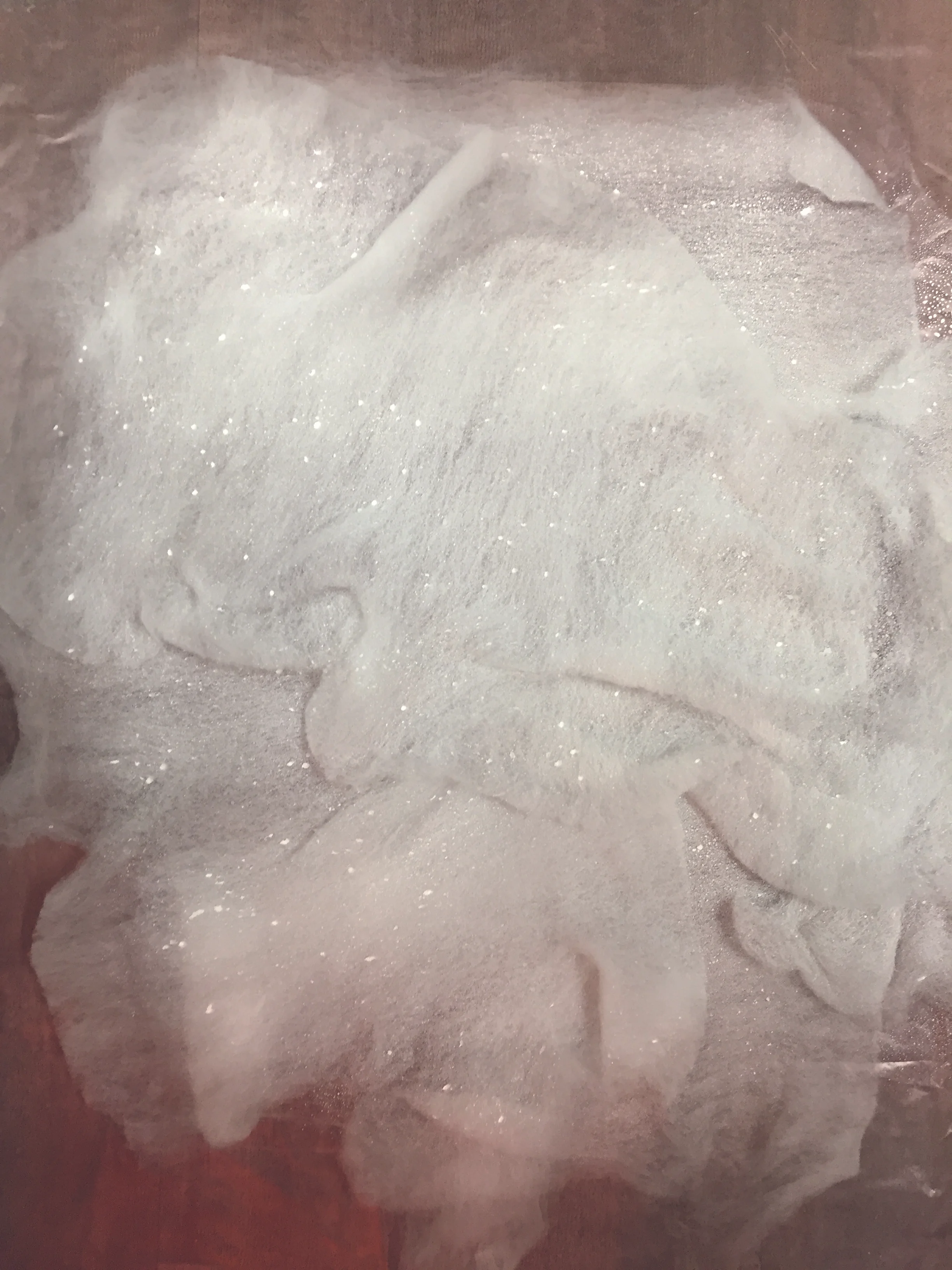 polyester web sprayed with latex bonding solution containing phosphorescent pigments