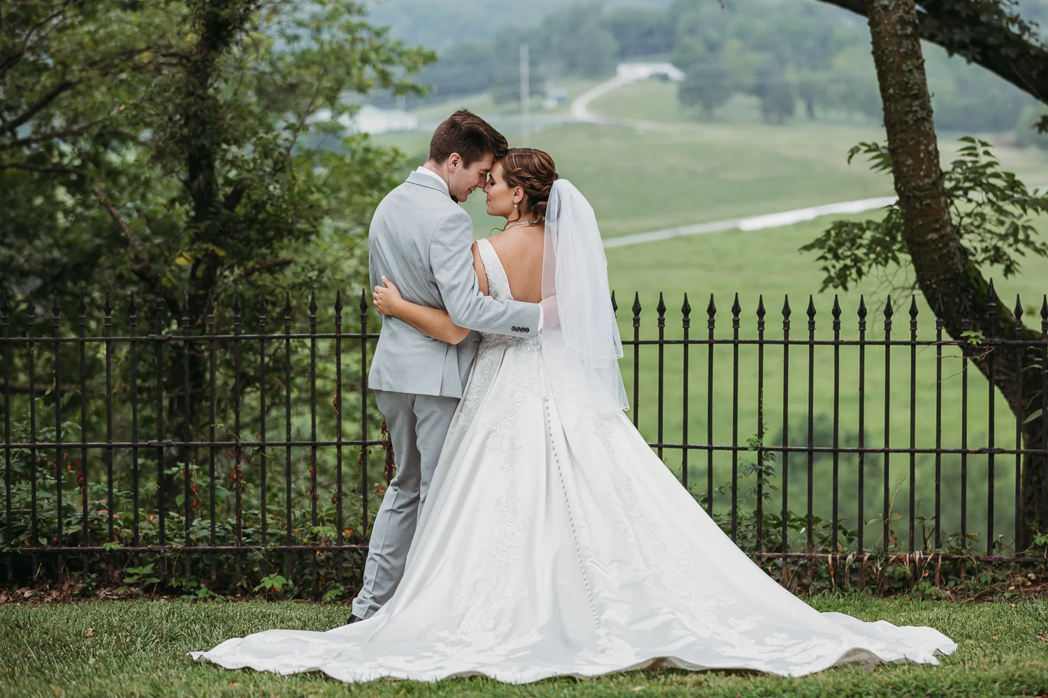 bride_groom_resting_foreheads_greenery-1.jpg