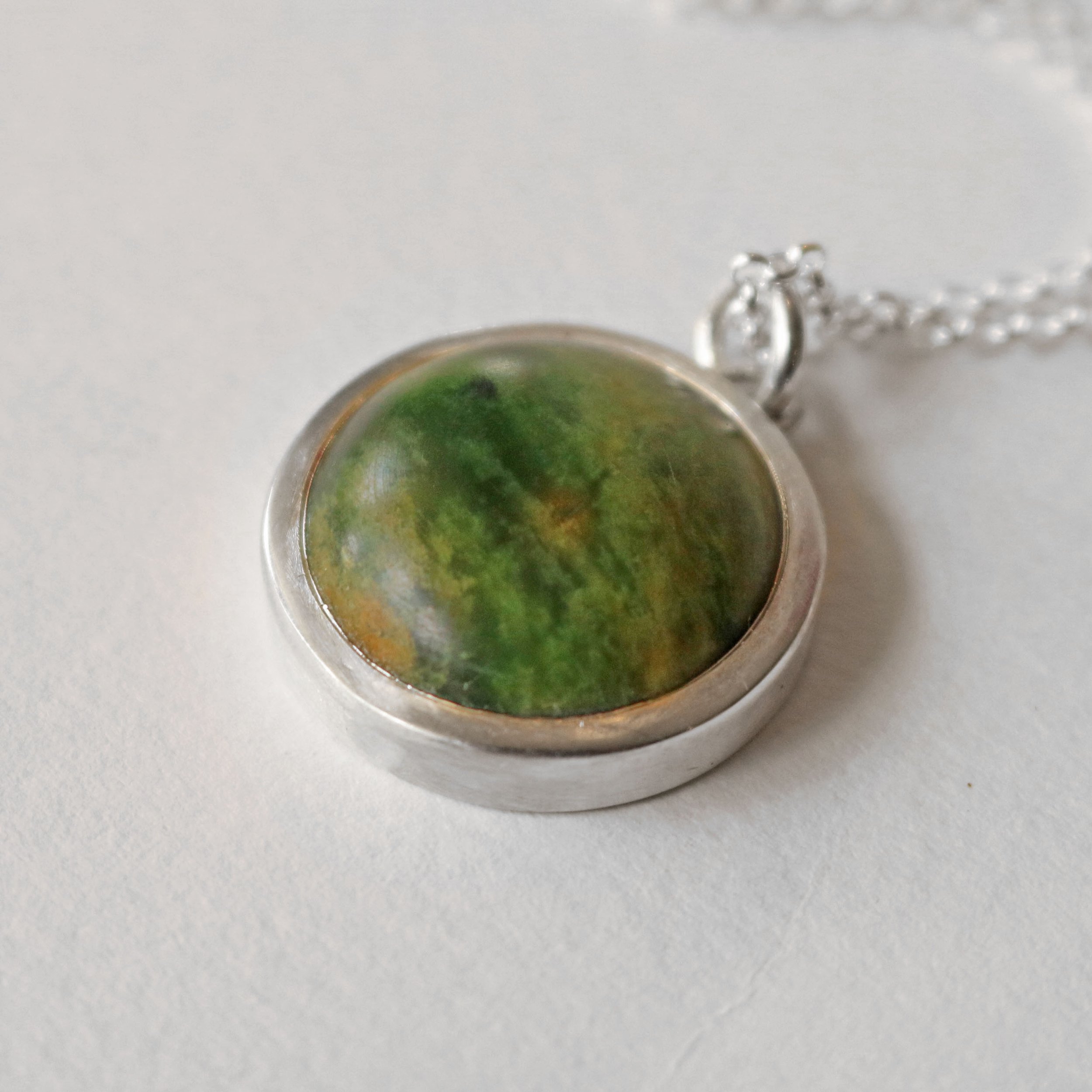 Marsden Pounamu silver round pendant 2.jpg