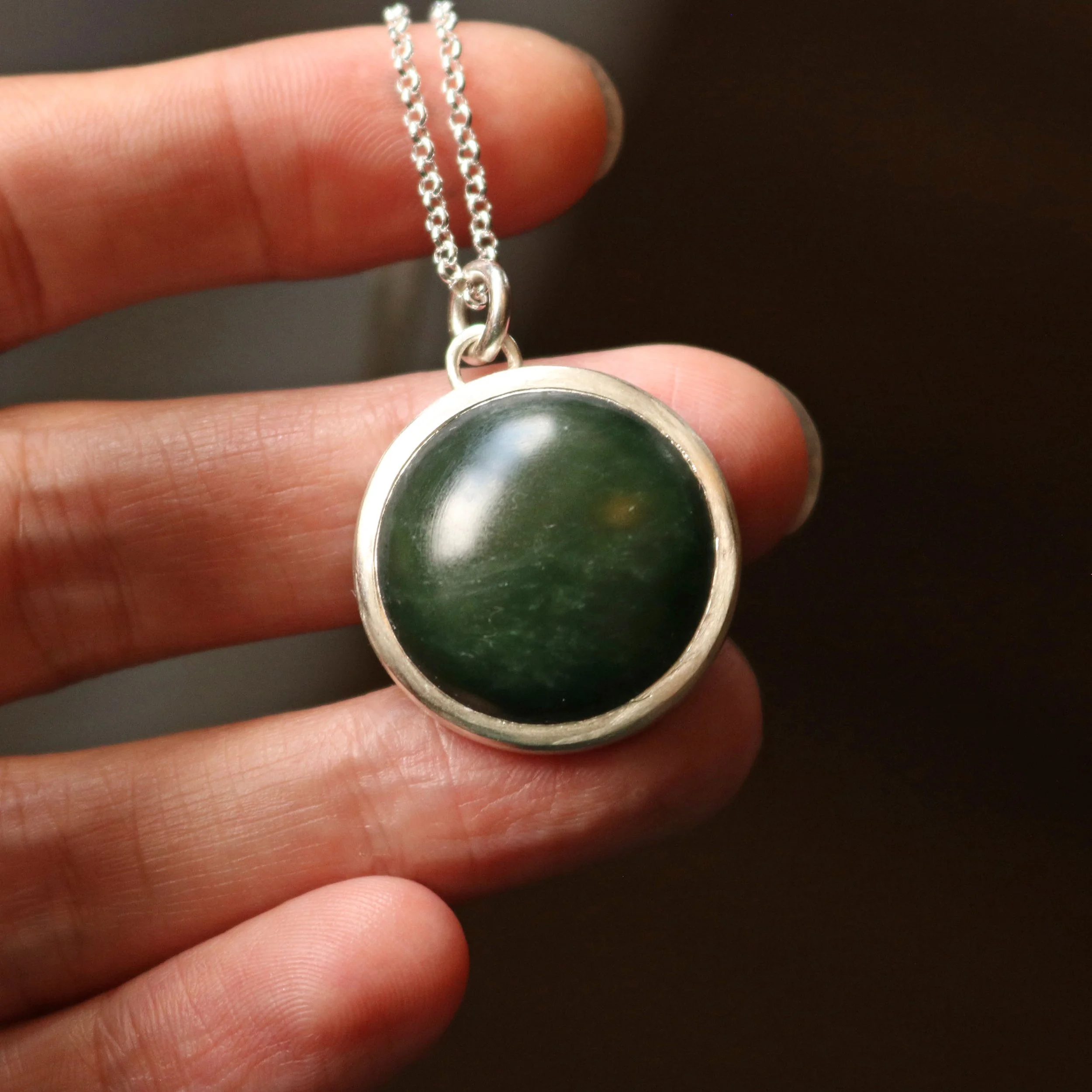Dark pounamu silver round pendant 2.jpg
