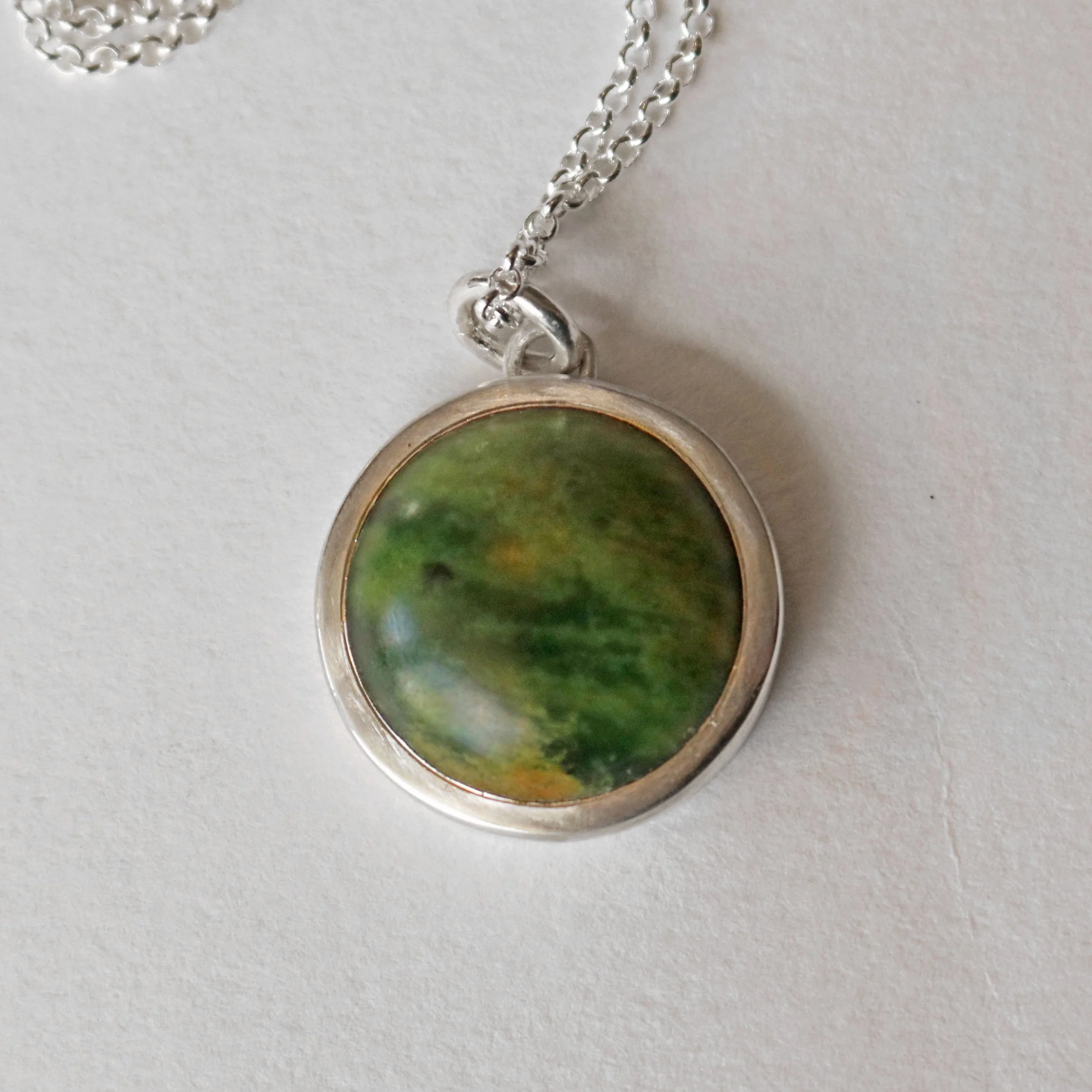 Marsden Pounamu silver round pendant.jpg