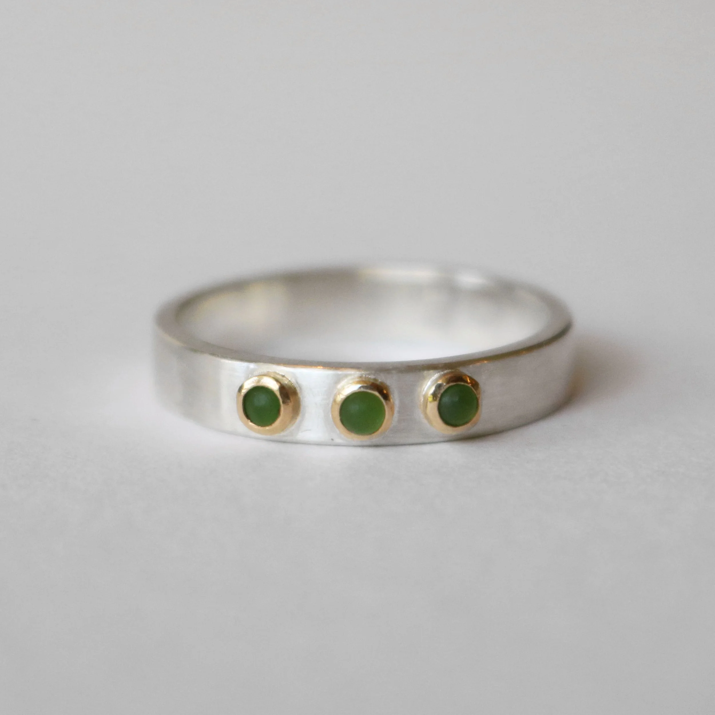 Triple Pounamu silver 18ct gold ring.jpg
