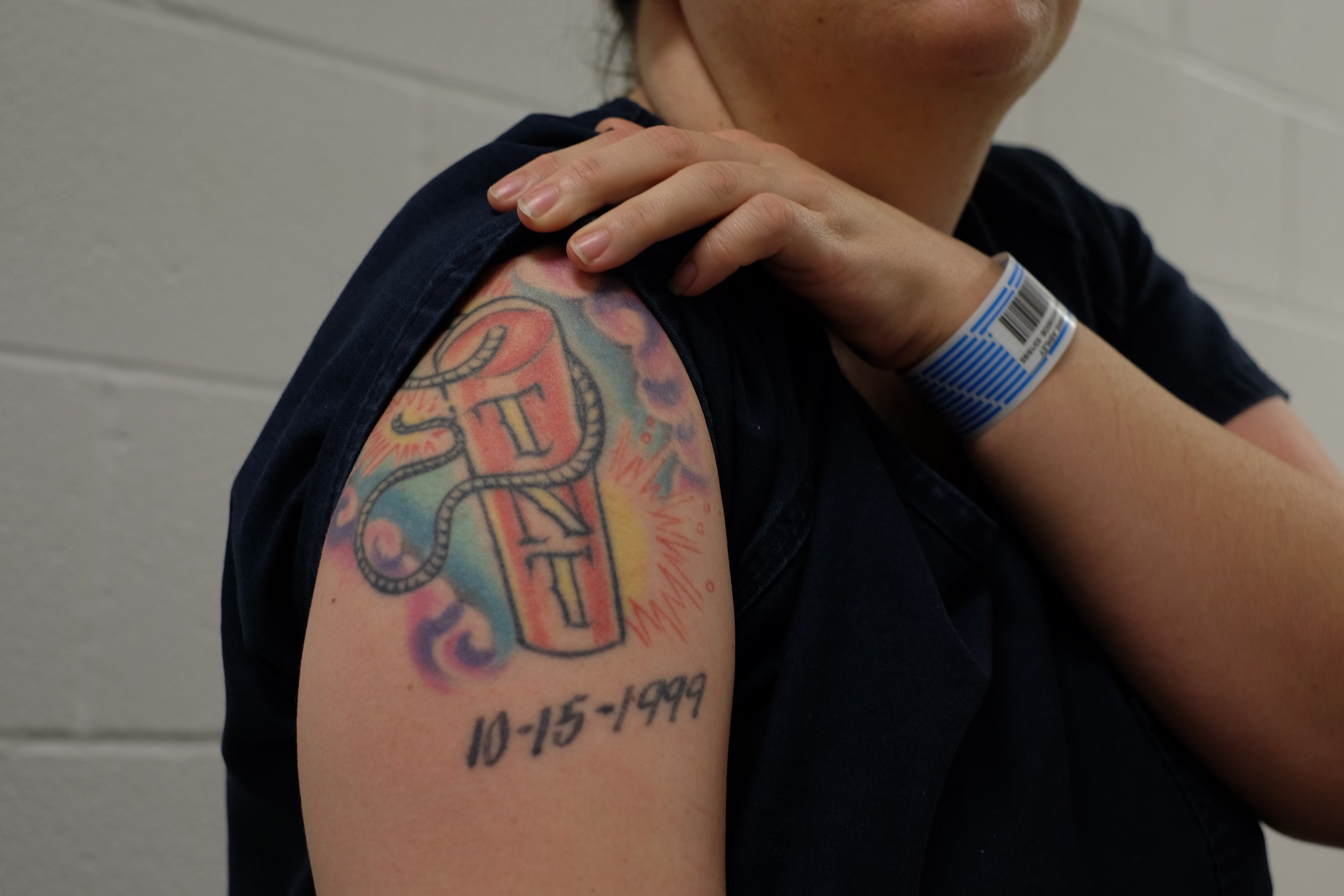  An inmate shows her tattoo. The date is the date when her mother died. This is her first day in Midland County jail. She had just been transferred after a year in TDC. Christmas Day, 2015. 