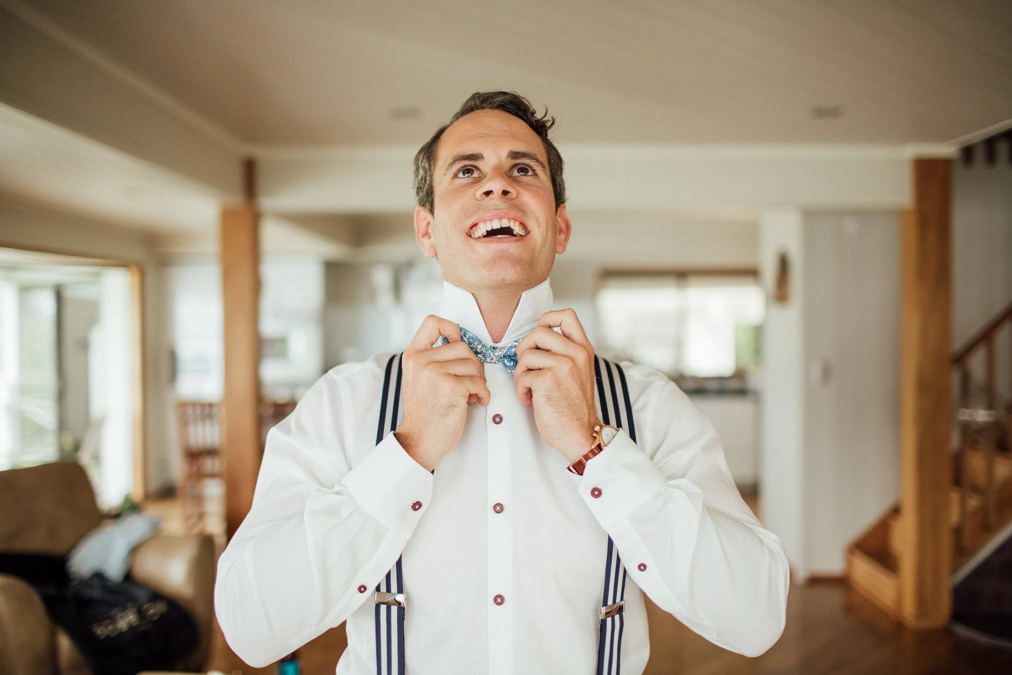 Wedding photography groom getting ready bowtie