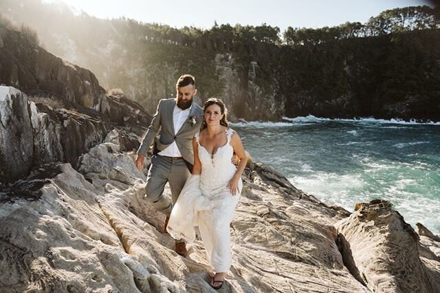 Sam and Michelle heading back to their reception after some epic photos on the cliff spot at Orua Beach House.