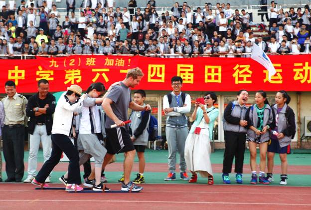  Annual Sports Day 2014. I am participating in a relay race with a student and a fellow English teacher.