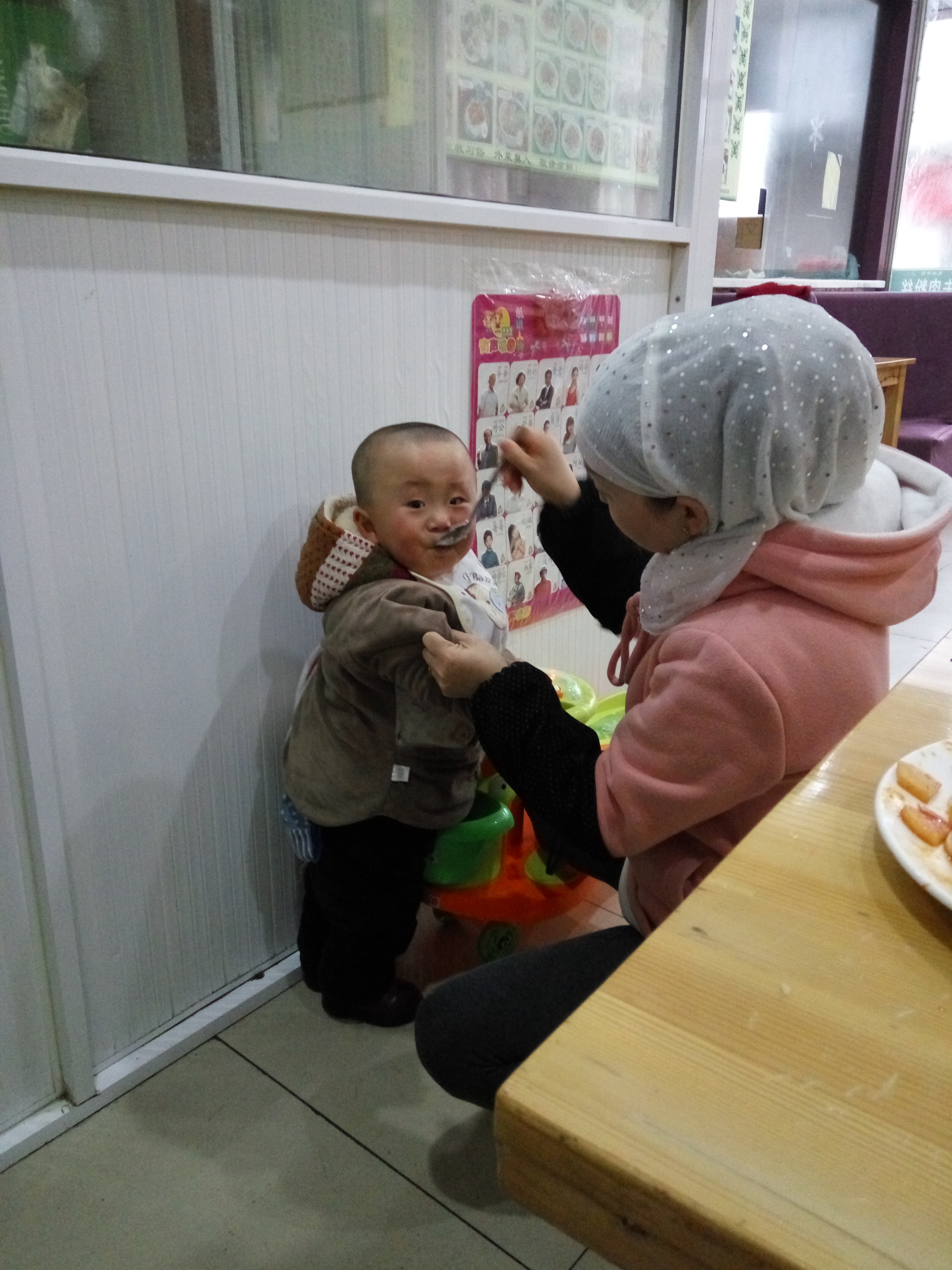 At another Muslim restaurant I watch a young mother wrangle in her son for dinner time.