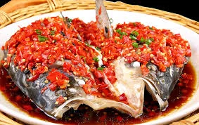 The fish head dish covered in a pepper sauce