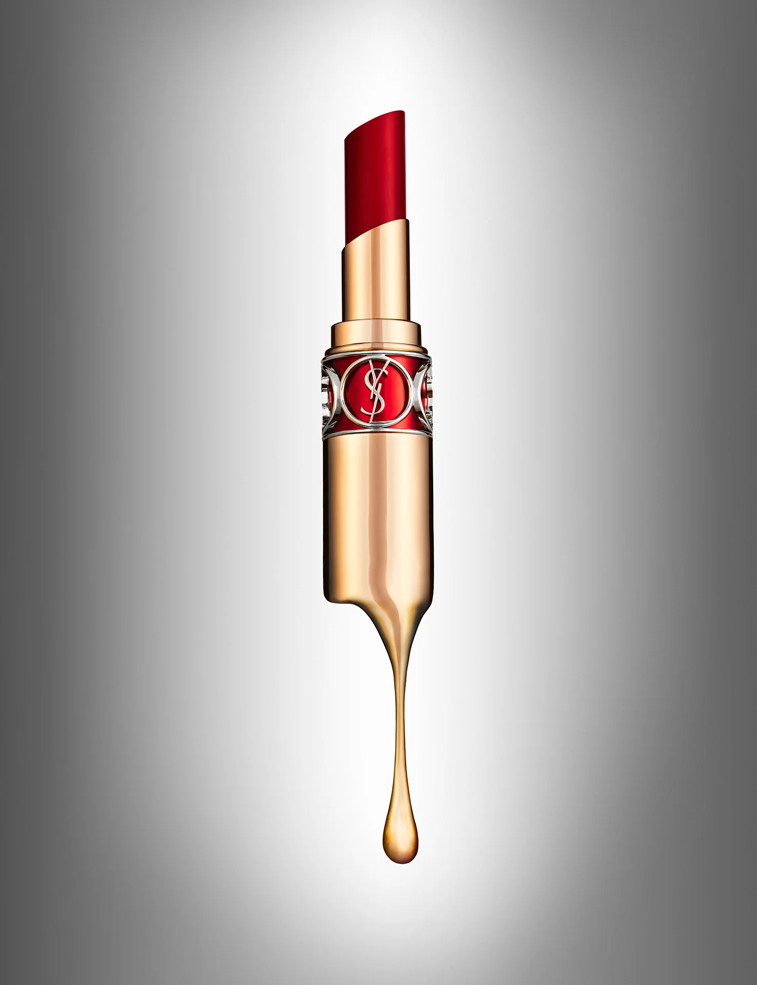 YSL lipstick dripping gold. Creative advertising editorial photography with luxury goods cosmetics by Yves Saint Laurent. Photography by Josh Caudwell still life photographer 