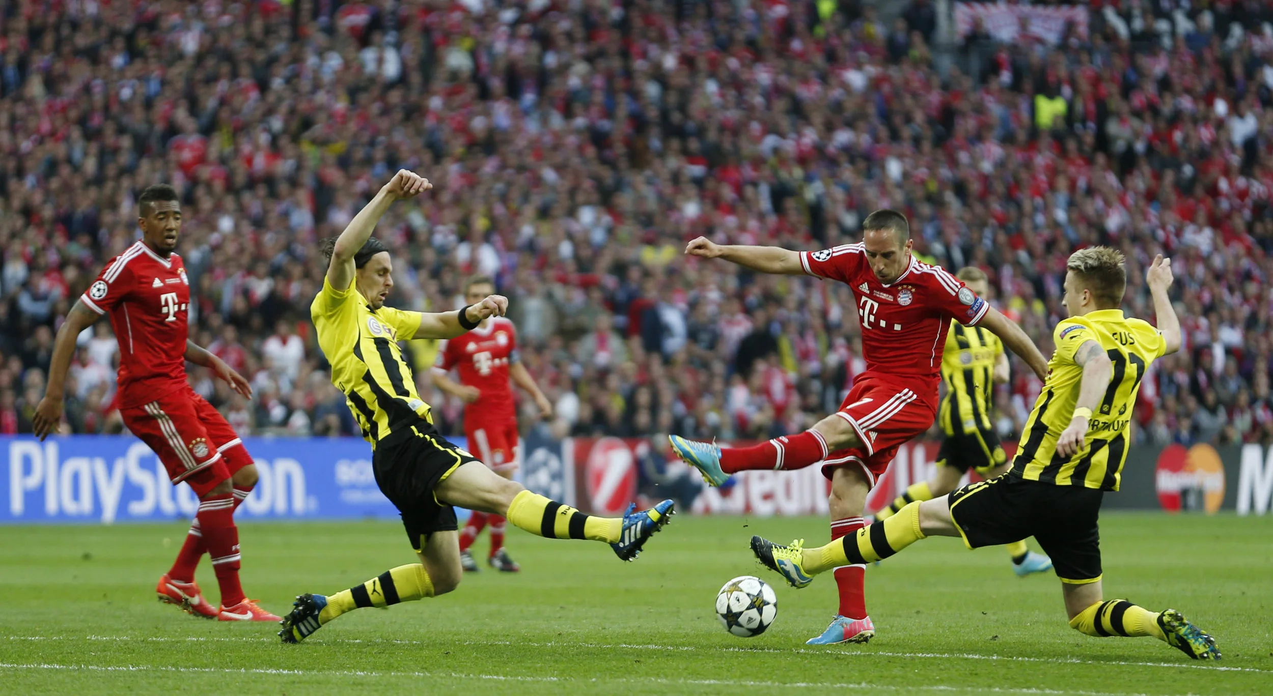 Frank Ribery (second from right) has his shot blocked by two Borussia Dortmund defenders in the 2013 UEFA Champions League Final. Both German clubs were managed by German coaches and the match featured 18 German players; a sign of a strong productio…