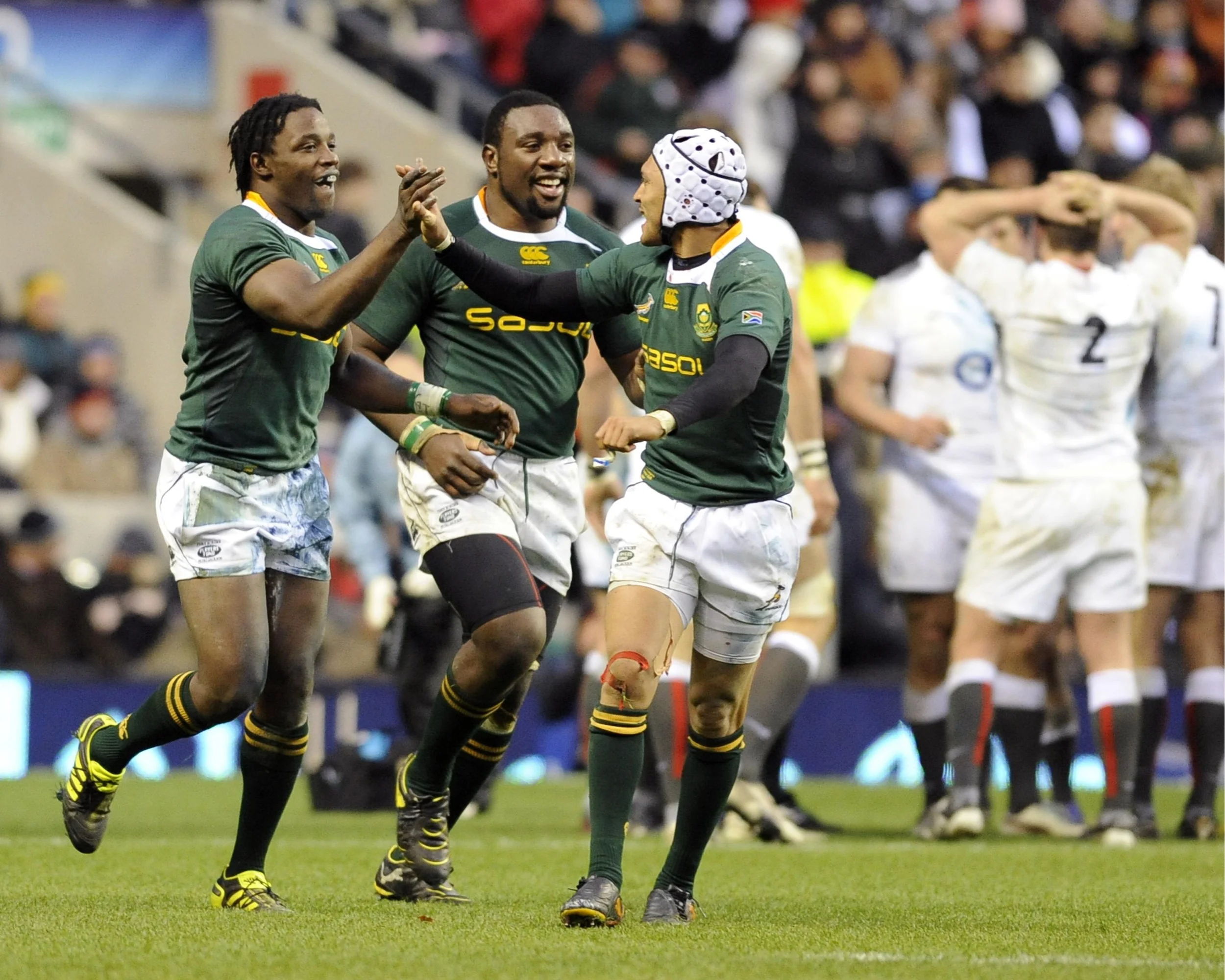 South Africa's Lwazi Mvovo (L) celebrates his try against England with Gio Aplon (R) and Tendai Mtawarira during their international rugby union match at Twickenham Stadium in London November 27, 2010. Image supplied by Action Images / Russell Cheyne