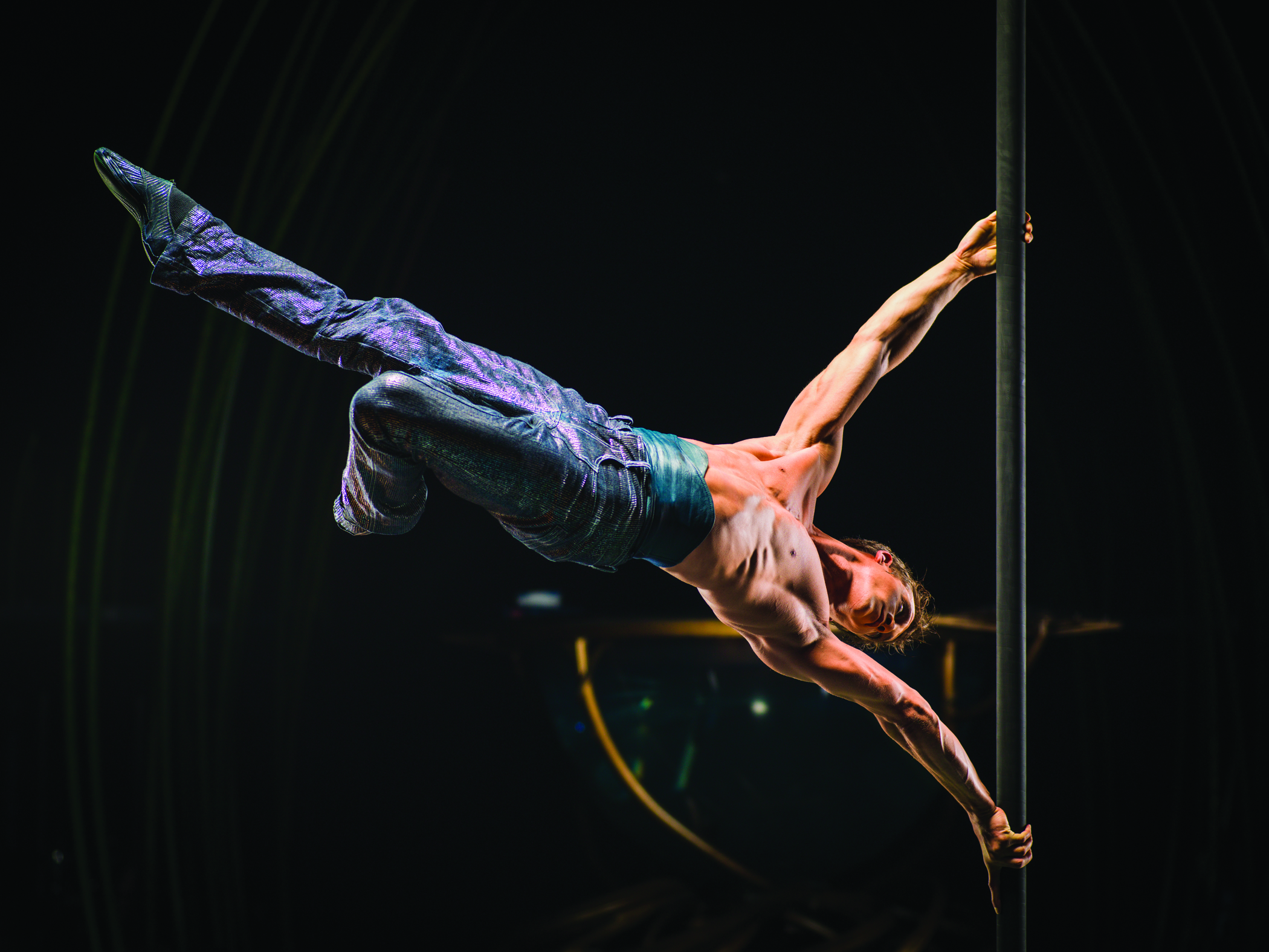 A performer demonstrates extreme athletic ability during a Cirque du Soleil performance, the kind of athletic ability that elite gymnasts have honed through years of competition. Image supplied by Cirque du Soleil. 