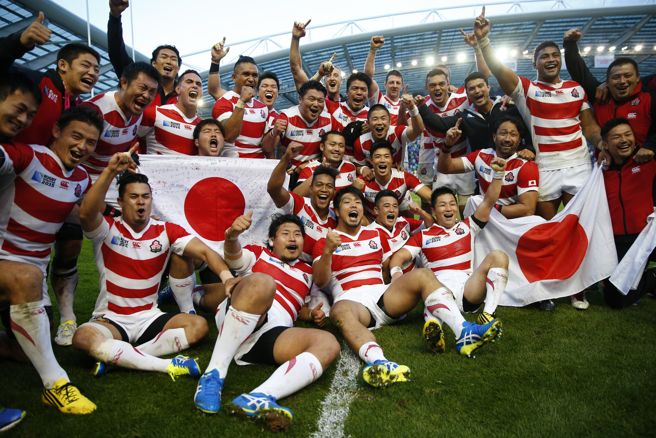 Japan celebrate one of the famous upsets in sport's history after they beat South Africa 34-32 in their opening game at the 2015 Rugby World Cup in Brighton, England. Image supplied by Action Images/ Eddie Keogh