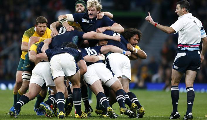 Craig Joubert (R) looks on as the Scottish and Australian packs wrestle for control in their quarter-final clash at the 2015 Rugby World Cup. Joubert has come under fire for his controversial decision to award Australia a penalty in the dying seconds of the match. Reuters / Stefan Wermuth