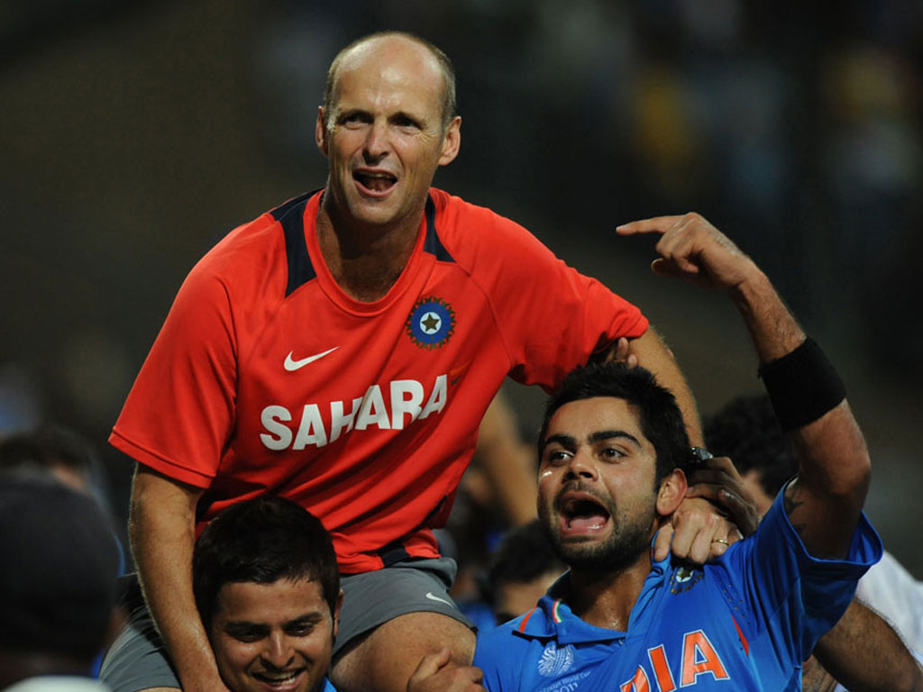 Gary Kirsten (C) celebrates with the Indian players after winning the 2011 Cricket World Cup. Kirsten initially faced challenges as the new coach of a team with great expectations but found his feet after establishing himself with senior players. 