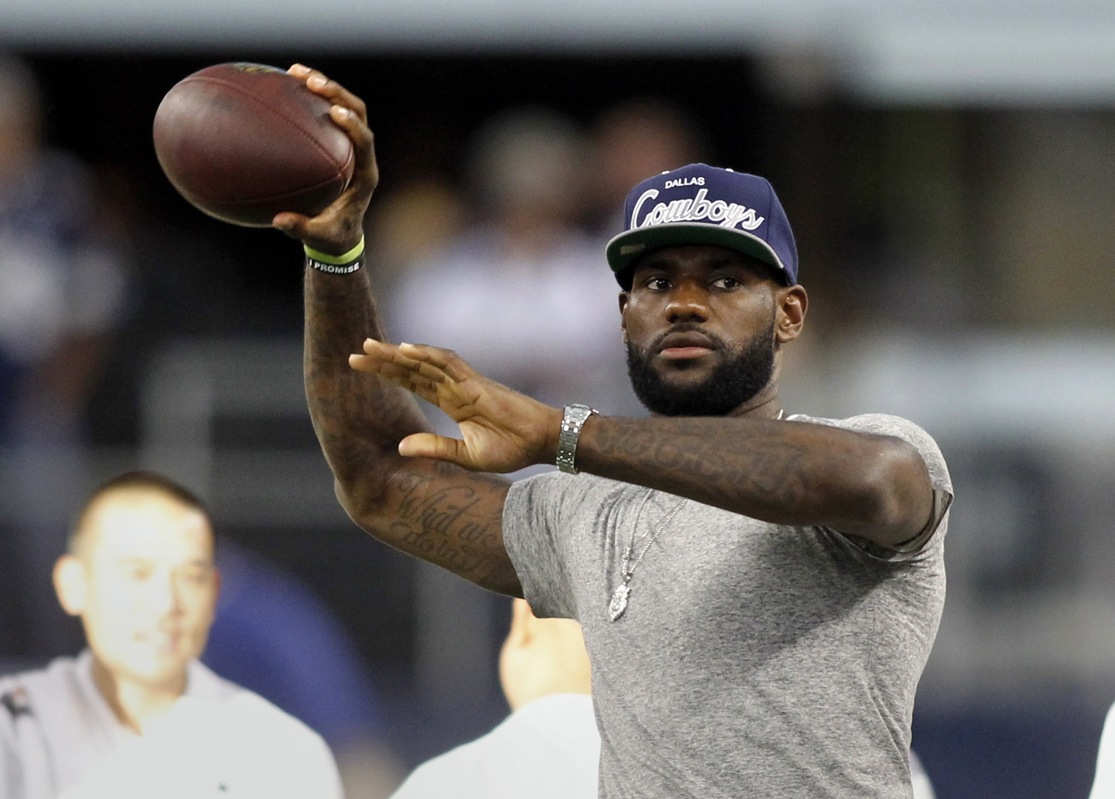 LeBron James throws a football before the start of the Dallas Cowboys' NFL football game against the New York Giants in 2013. James, one of the greatest NBA basketball players of all time, grew up playing a variety of sports. Image supplied by Action Images / Mike Stone. 